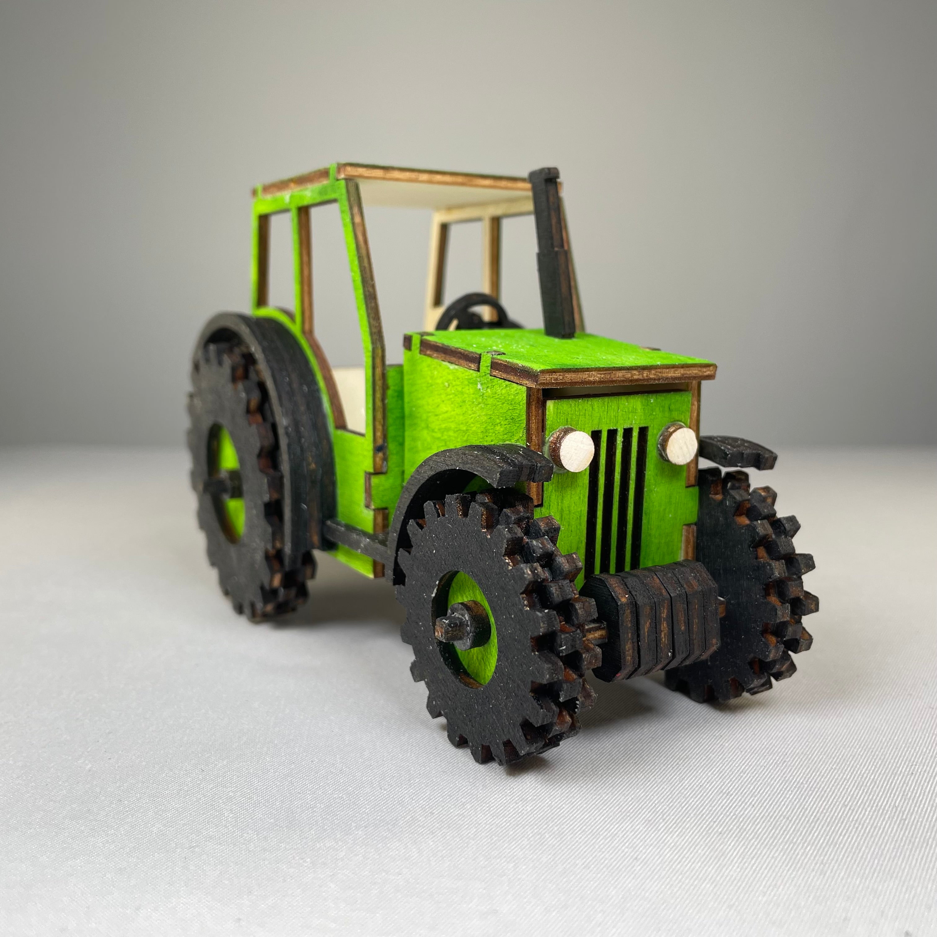 Curious Rabbit garden tractor puzzle flatpack model kit with colorful, detailed tractor pieces for assembling and display.