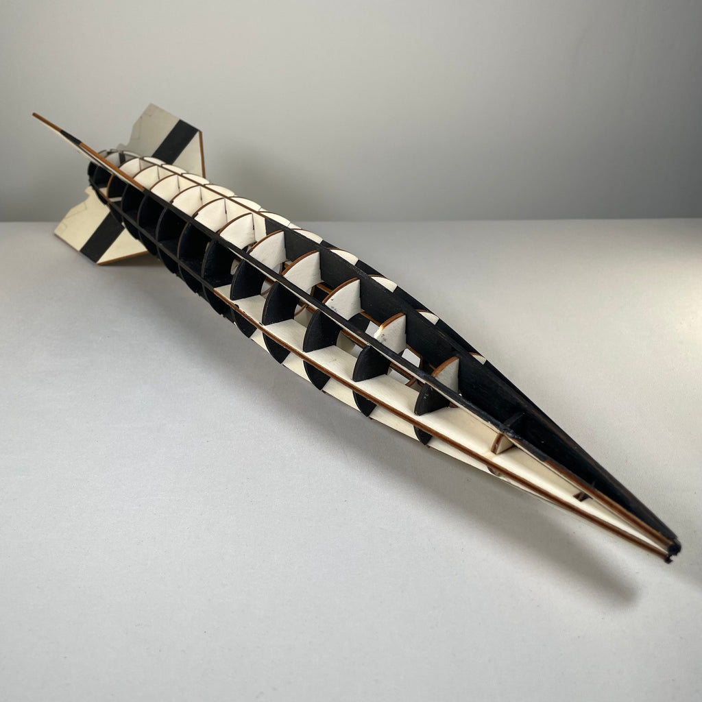 Curious Rabbit Prop V2 Rocket flatpack model kit, historical science toy with assembled rocket displayed on a table.