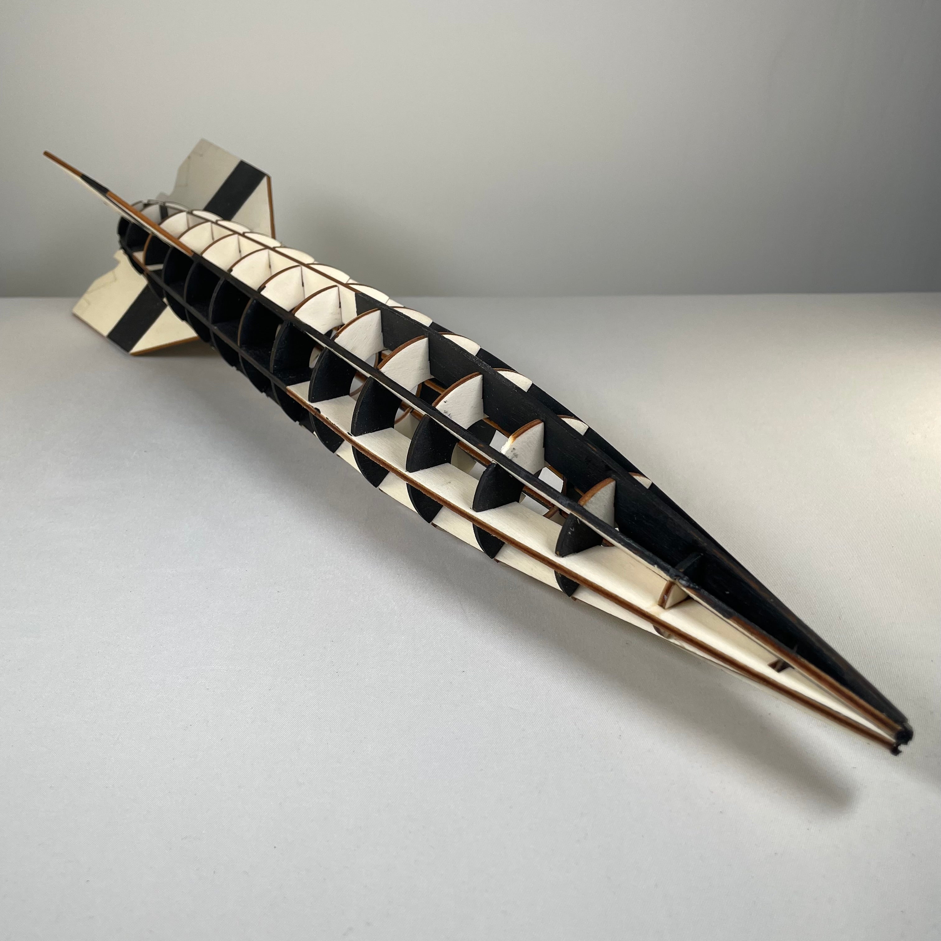 Curious Rabbit Prop V2 Rocket flatpack model kit, historical science toy with assembled rocket displayed on a table.