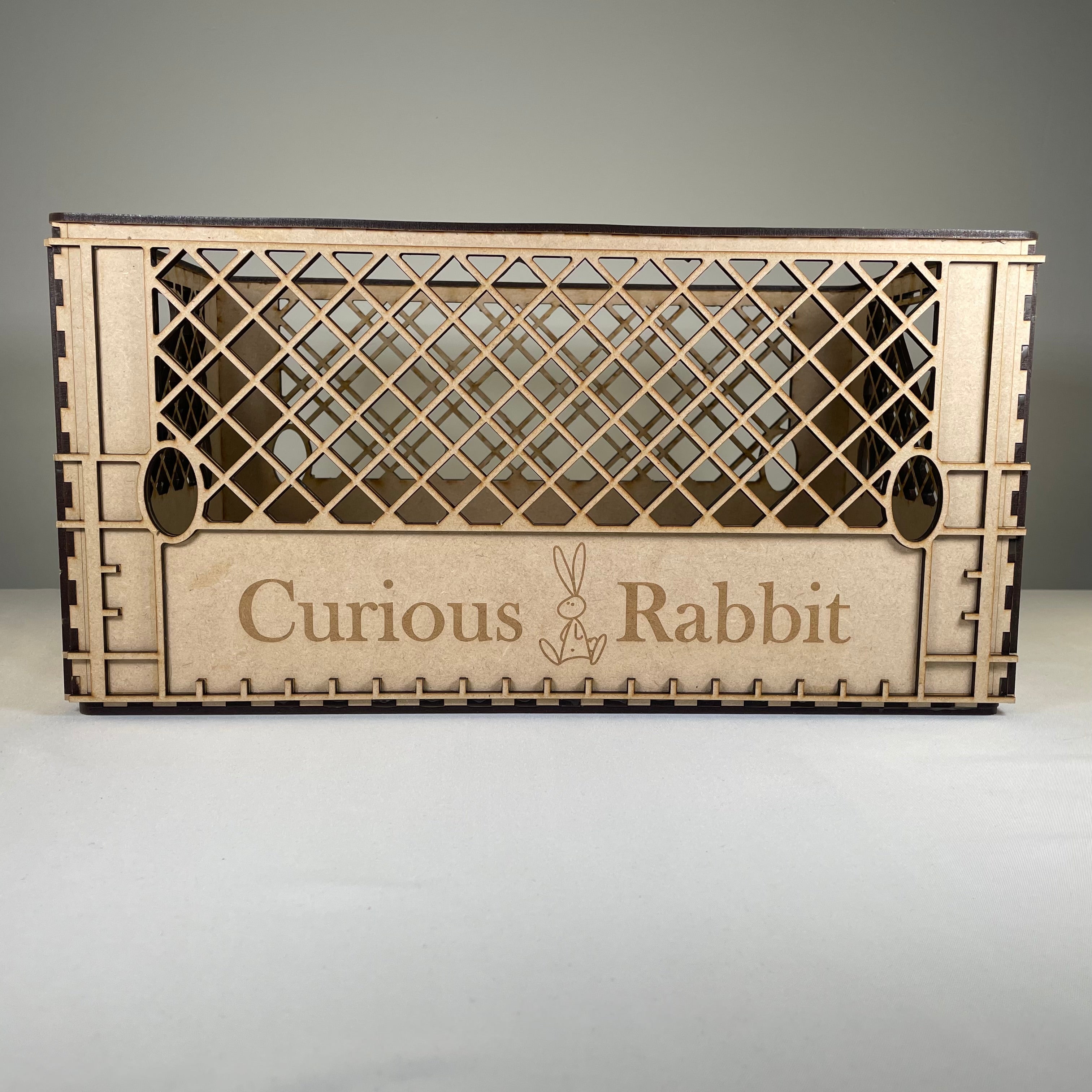 Vintage Curious Rabbit milk crate flatpack model kit, showing assembled wooden crate with slatted sides and sturdy construction.