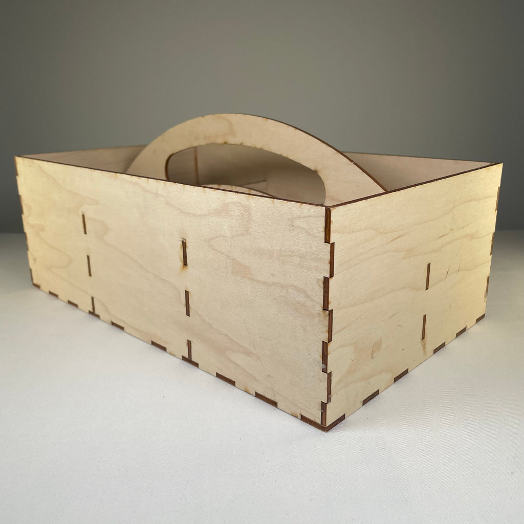 Curious Rabbit seedbox with handle in flatpack garden kit, showing assembled wooden container with handle for planting and storage.