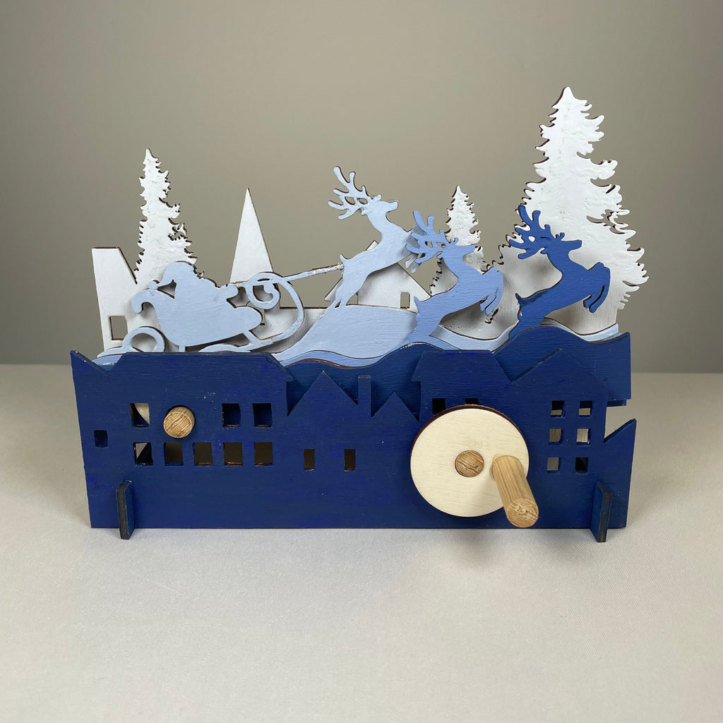 Curious Rabbit mechanical Santa sleigh flatpack model kit, festive Christmas craft with detailed wooden parts and assembly components.