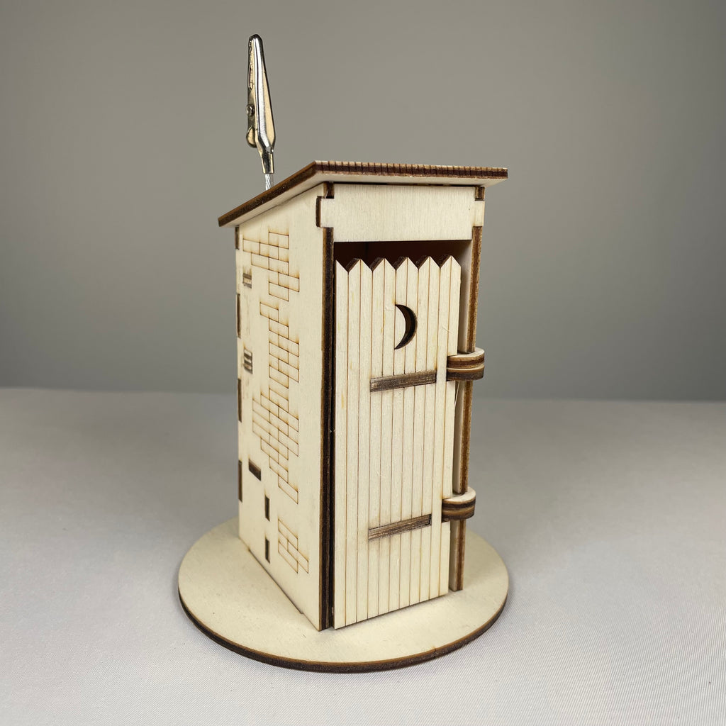 Curious Rabbit Outhouse Toilet flatpack memo holder featuring architecture design, made for decorative and functional desk use.