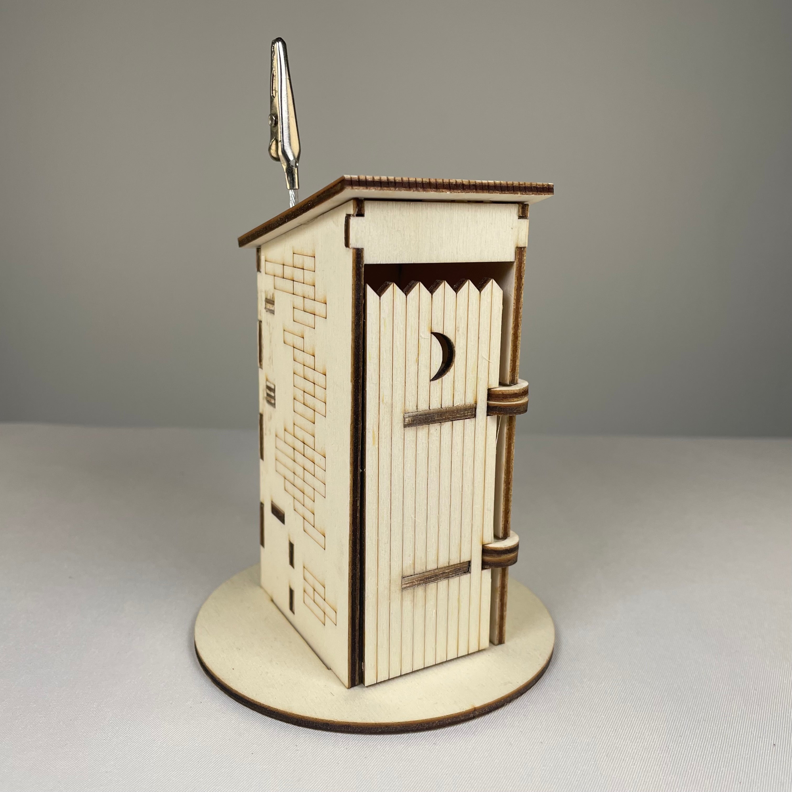 Curious Rabbit Outhouse Toilet flatpack memo holder featuring architecture design, made for decorative and functional desk use.