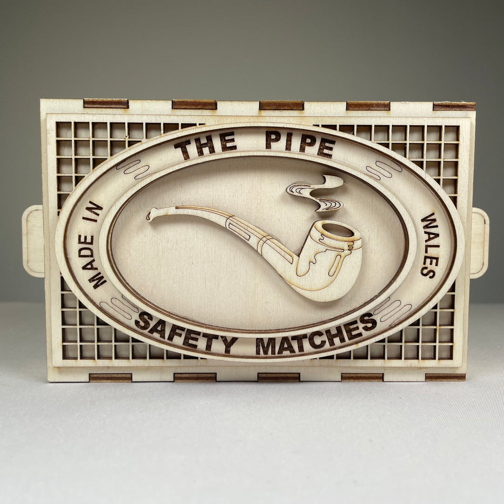 Vintage Curious Rabbit matchbox pipe flatpack model kit with assembled pipe and packaging on a white background.