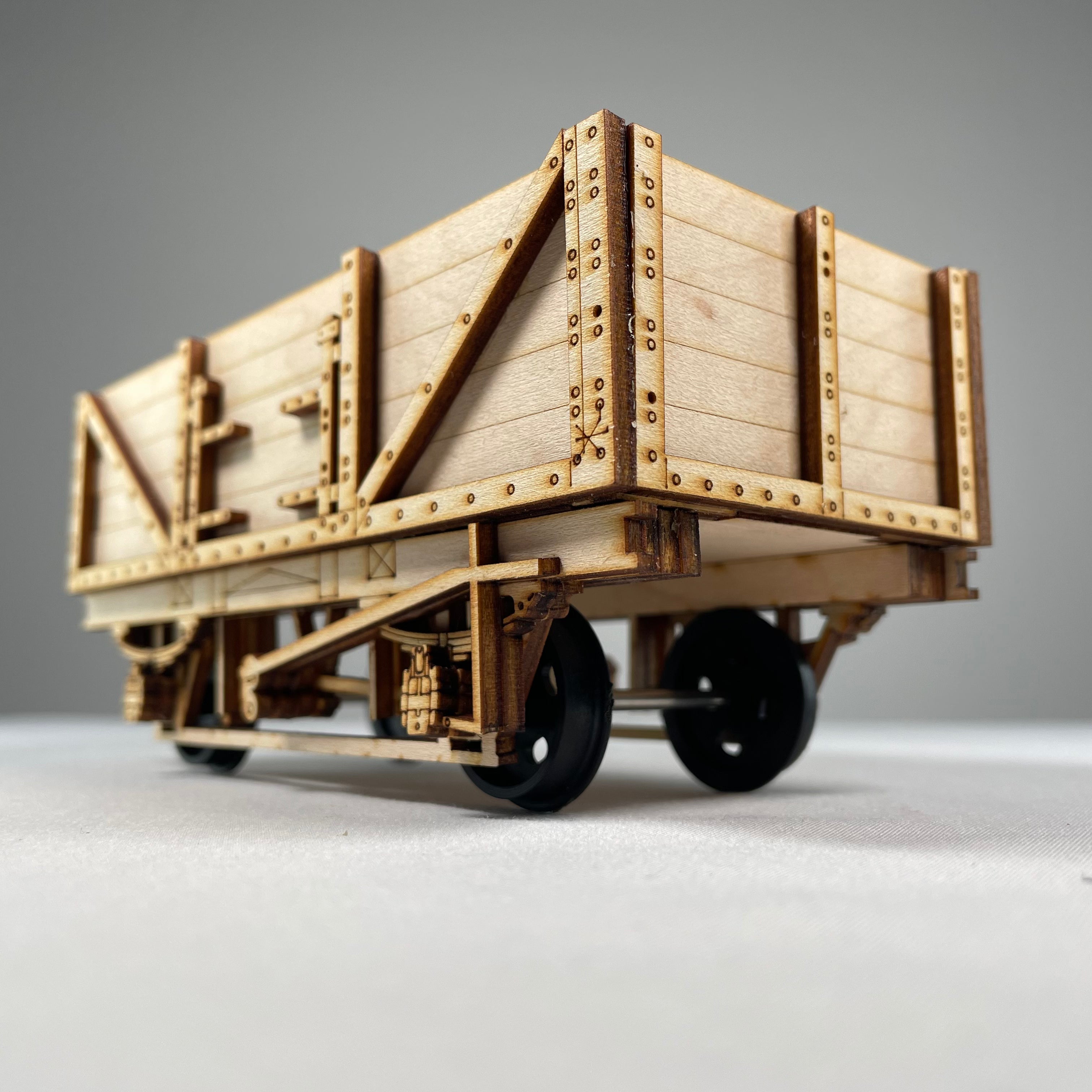 Curious Rabbit Railway train wagon model showcasing detailed wooden design and realistic features on a wooden track.