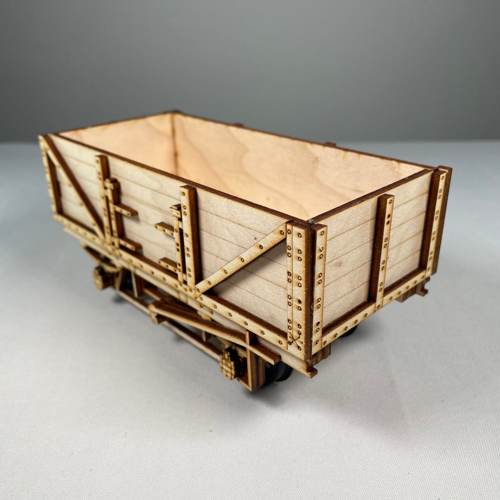 Curious Rabbit flatpack railway train wagon model kit, showing assembled wooden flatbed with detailed craftsmanship.