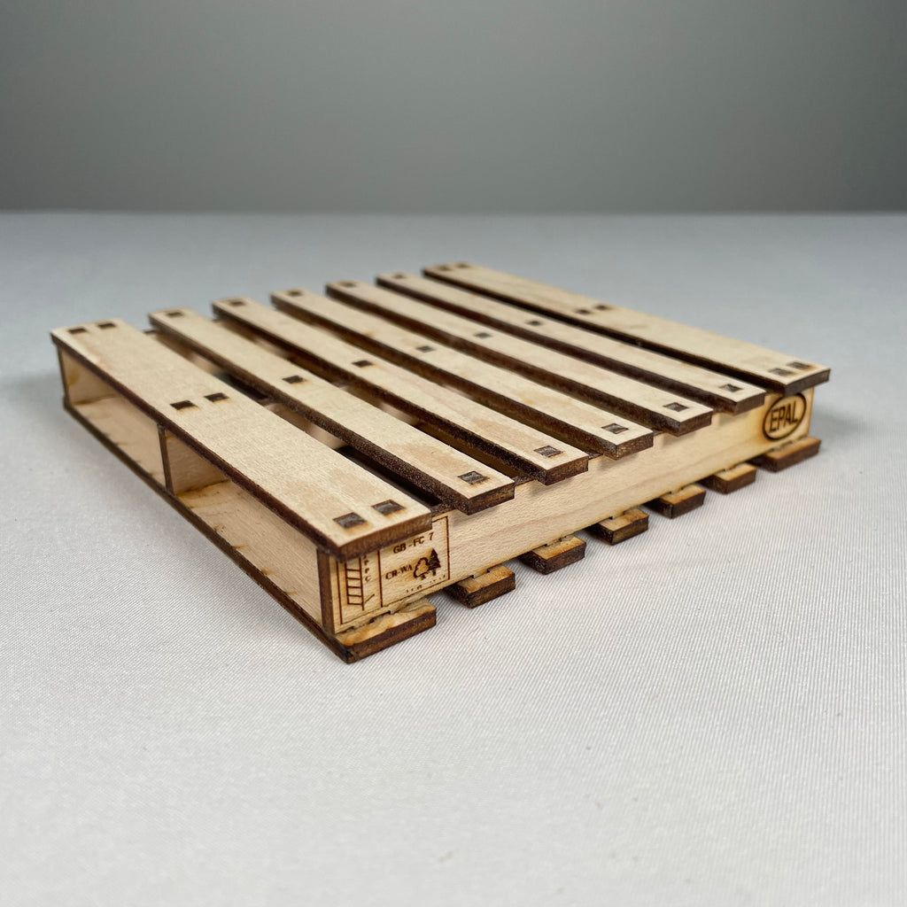 Curious Rabbit flatpack pallet coaster icons kit, showing assembled wooden coaster with pallet design and natural wood finish.