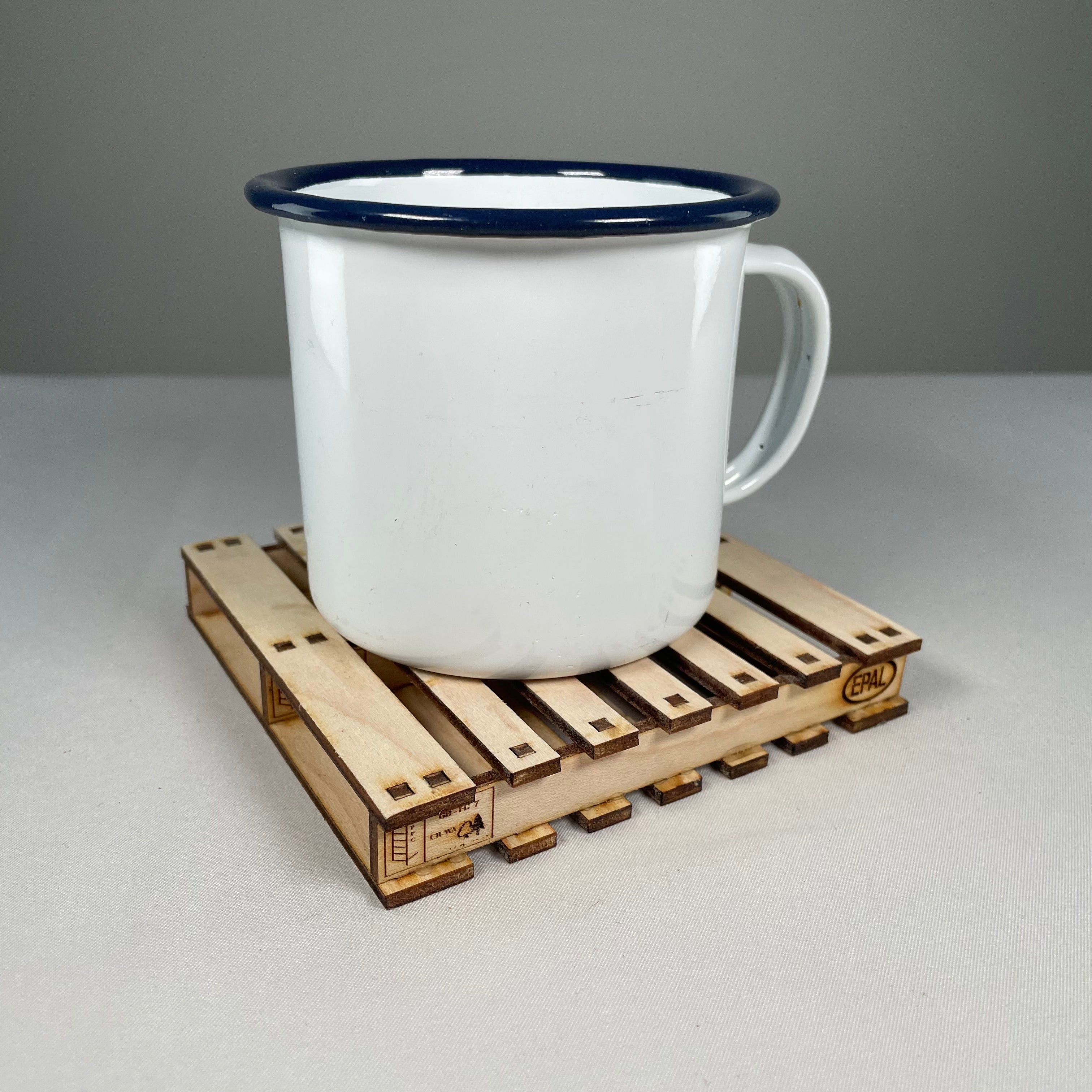 Curious Rabbit flatpack pallet coaster icon kit with assembled wooden coaster and packaging, displayed on a white background.