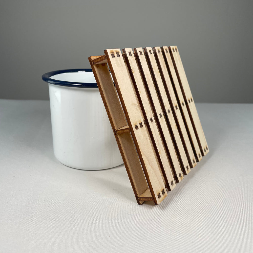 Curious Rabbit pallet coaster flatpack model kit featuring icon-style wooden coaster with geometric design.