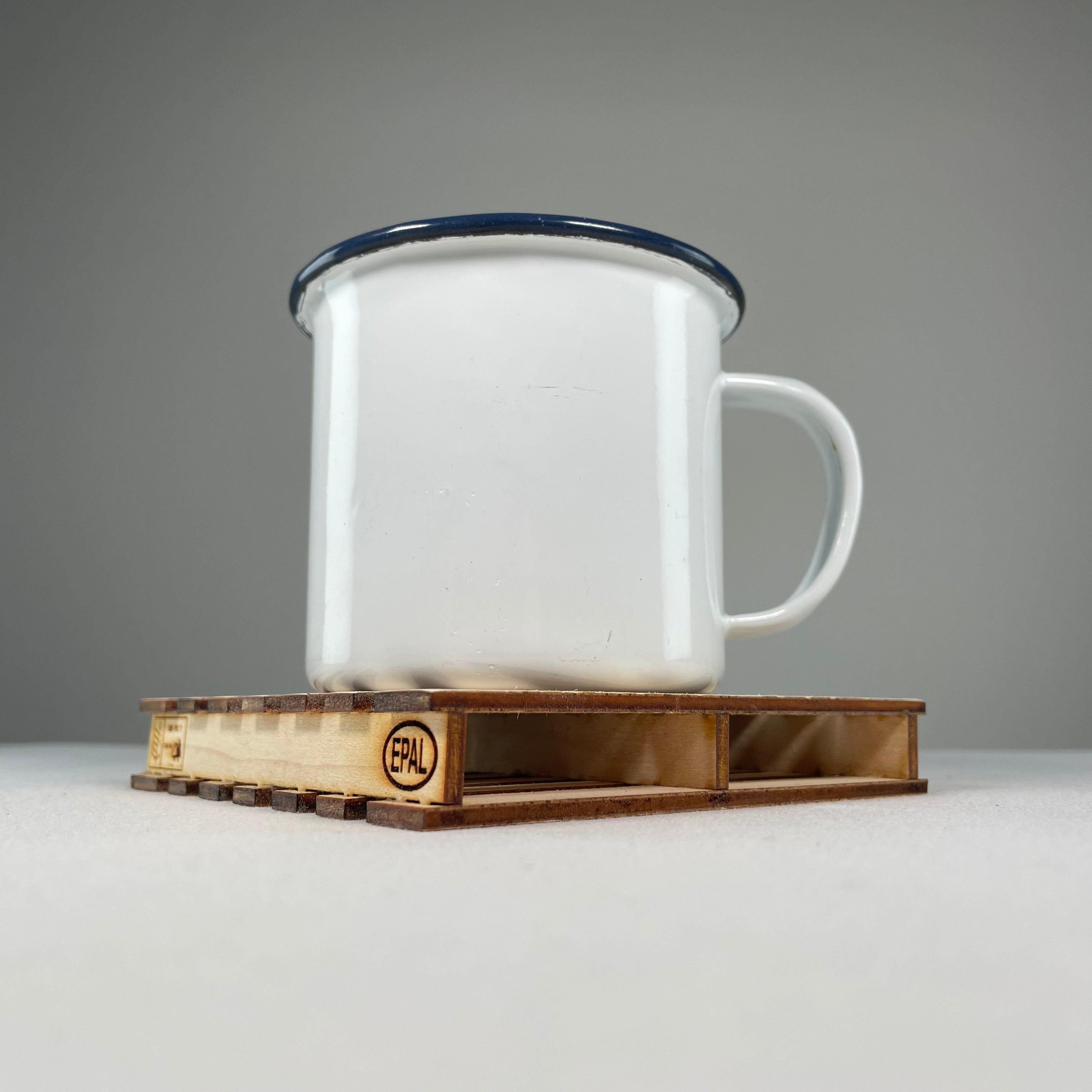 Curious Rabbit flatpack pallet coaster icon kit featuring assembled wooden pallet coasters on a white background.