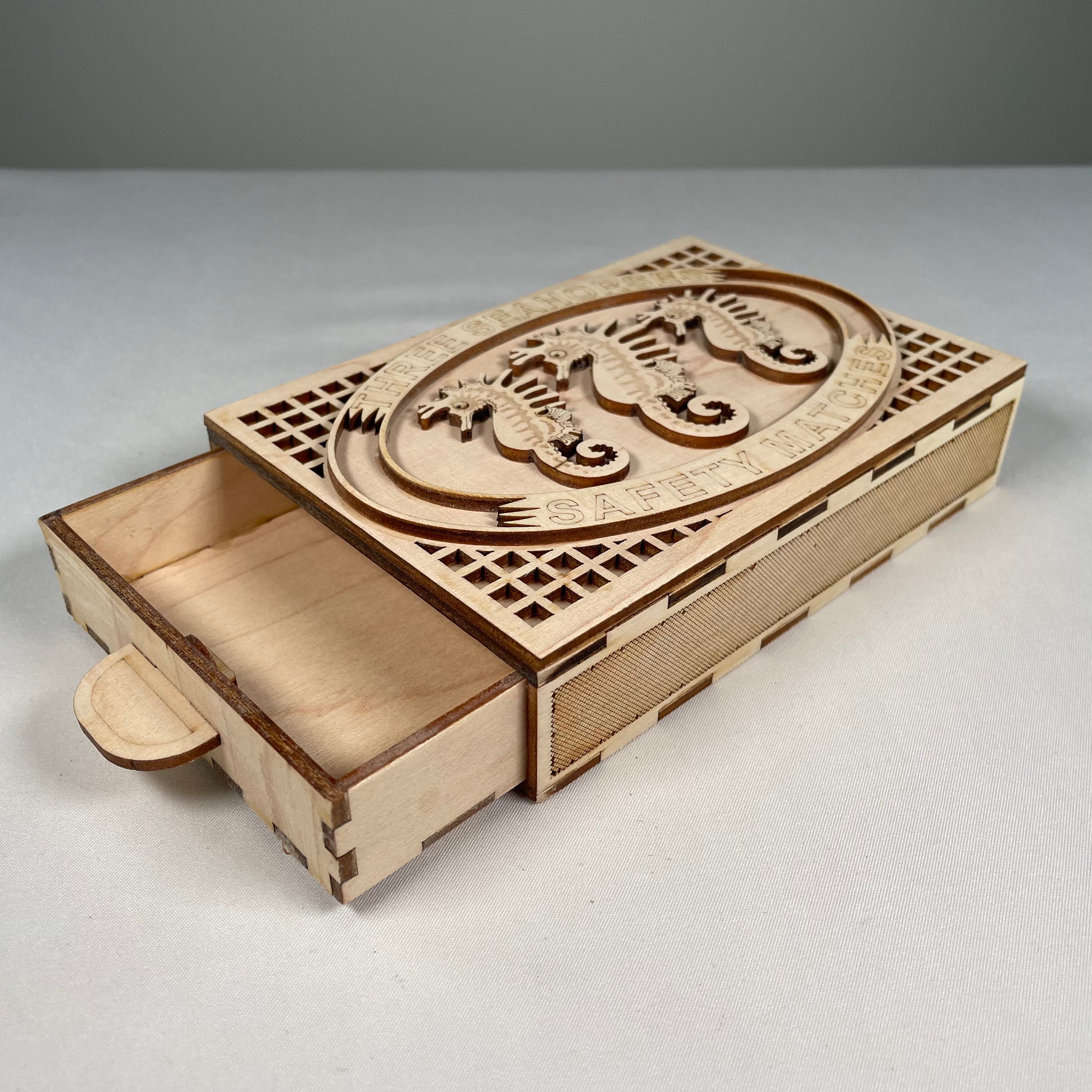 Vintage Curious Rabbit Matchbox flatpack model kit featuring a detailed seahorse design with assembled and unassembled parts.