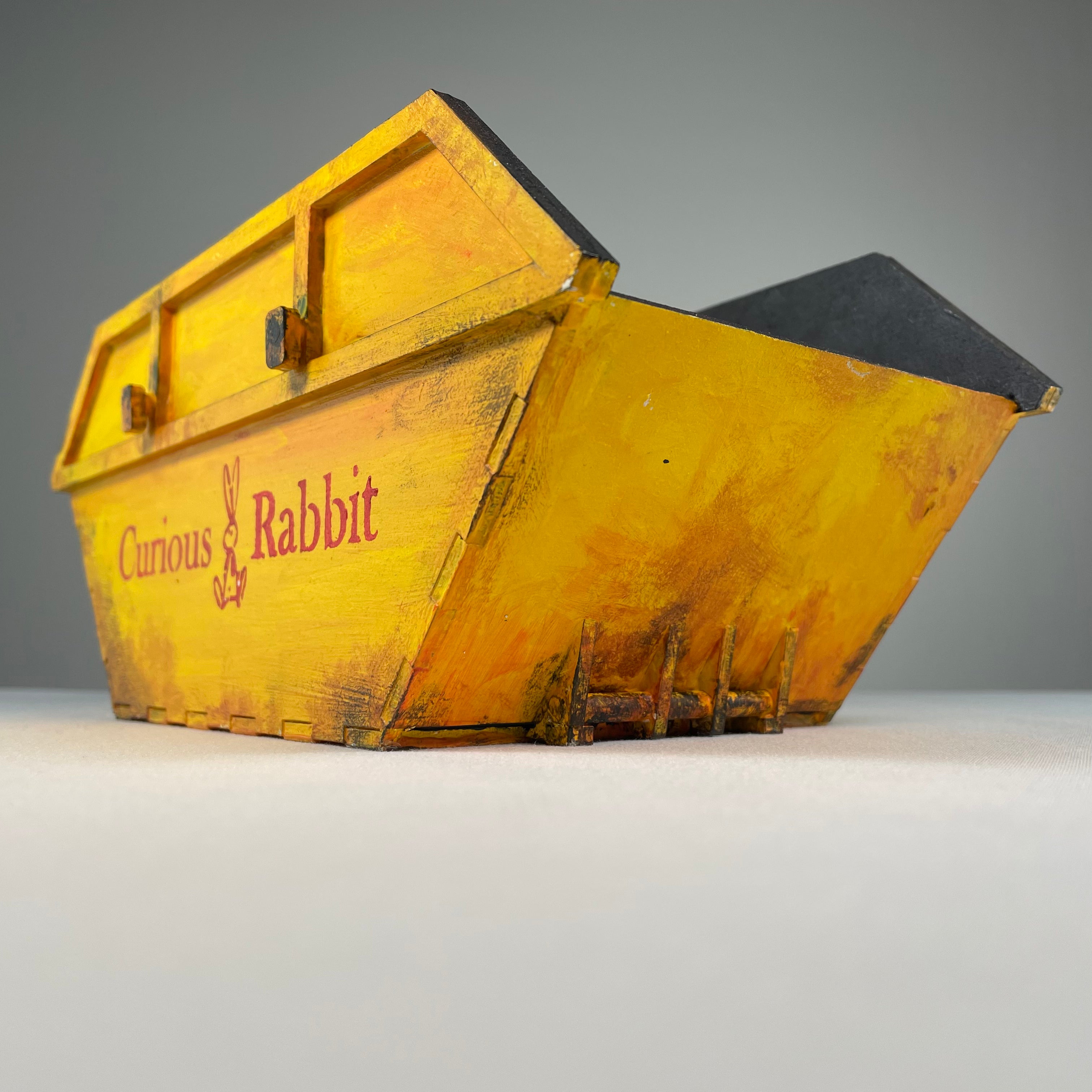 Curious Rabbit flatpack skip waste container icon kit, showcasing a compact, modular design for waste disposal illustration