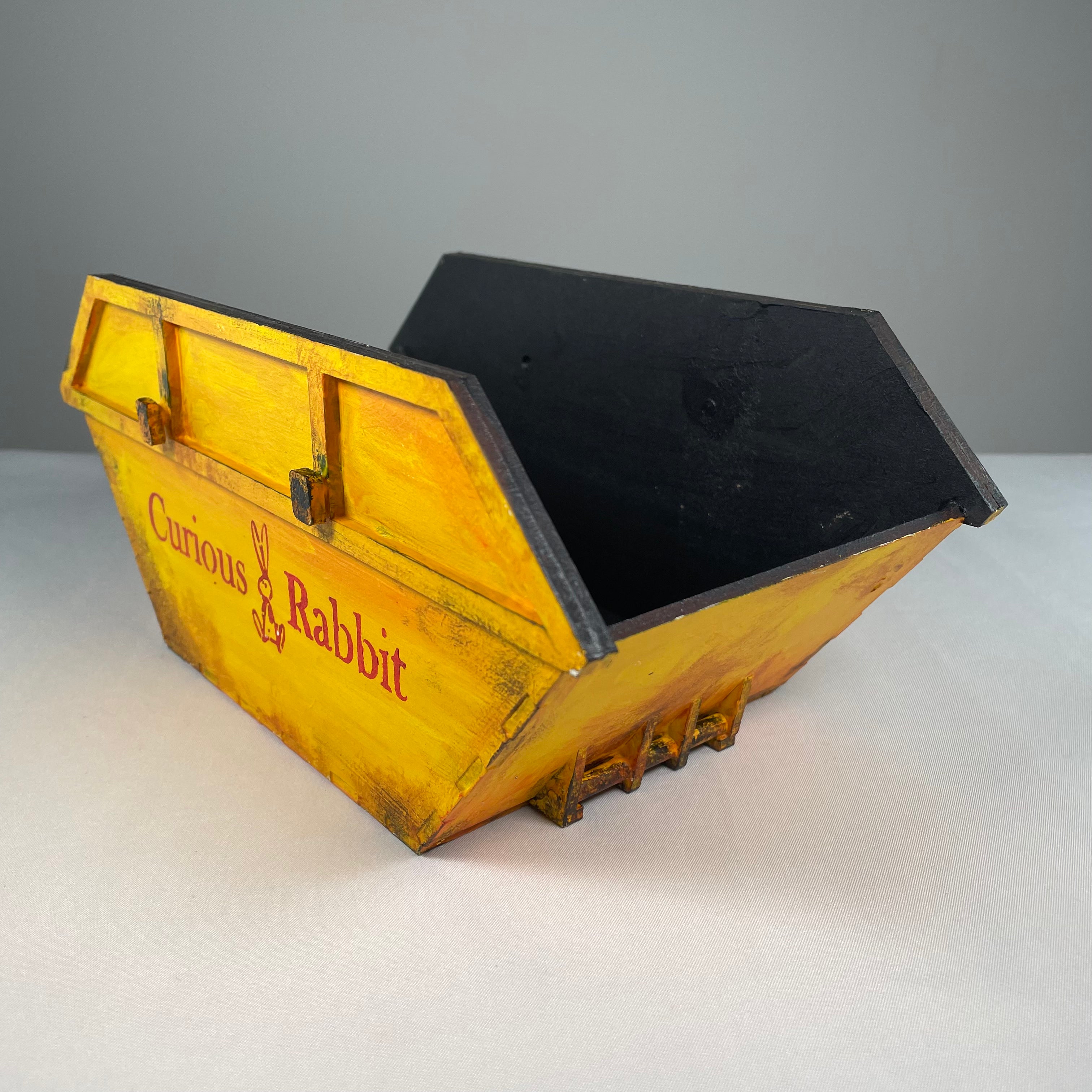 Icons of the Curious Rabbit Skip Waste Container Flatpack Model Kit, showing colorful, detailed illustrations of the product design.