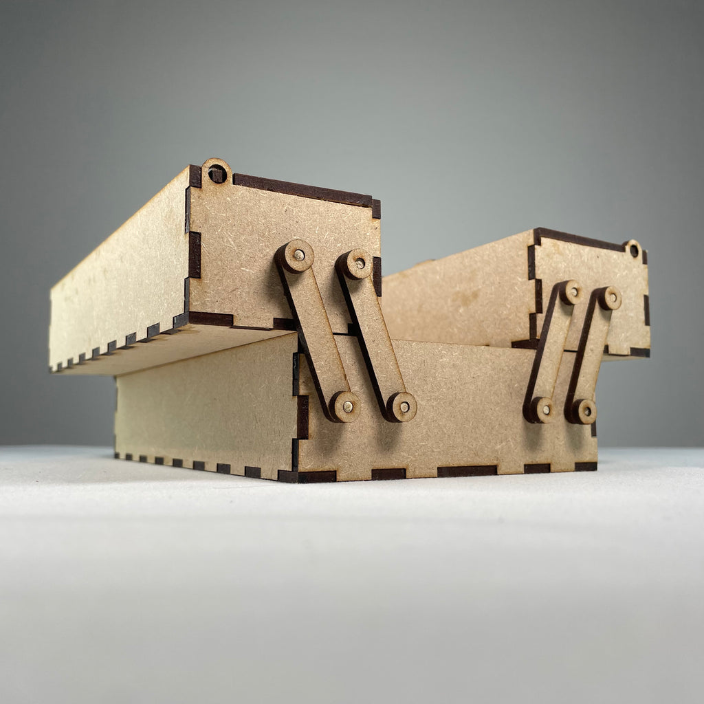Two-tier flatpack Curious Rabbit toolbox with open compartments and handle, ready for assembly.