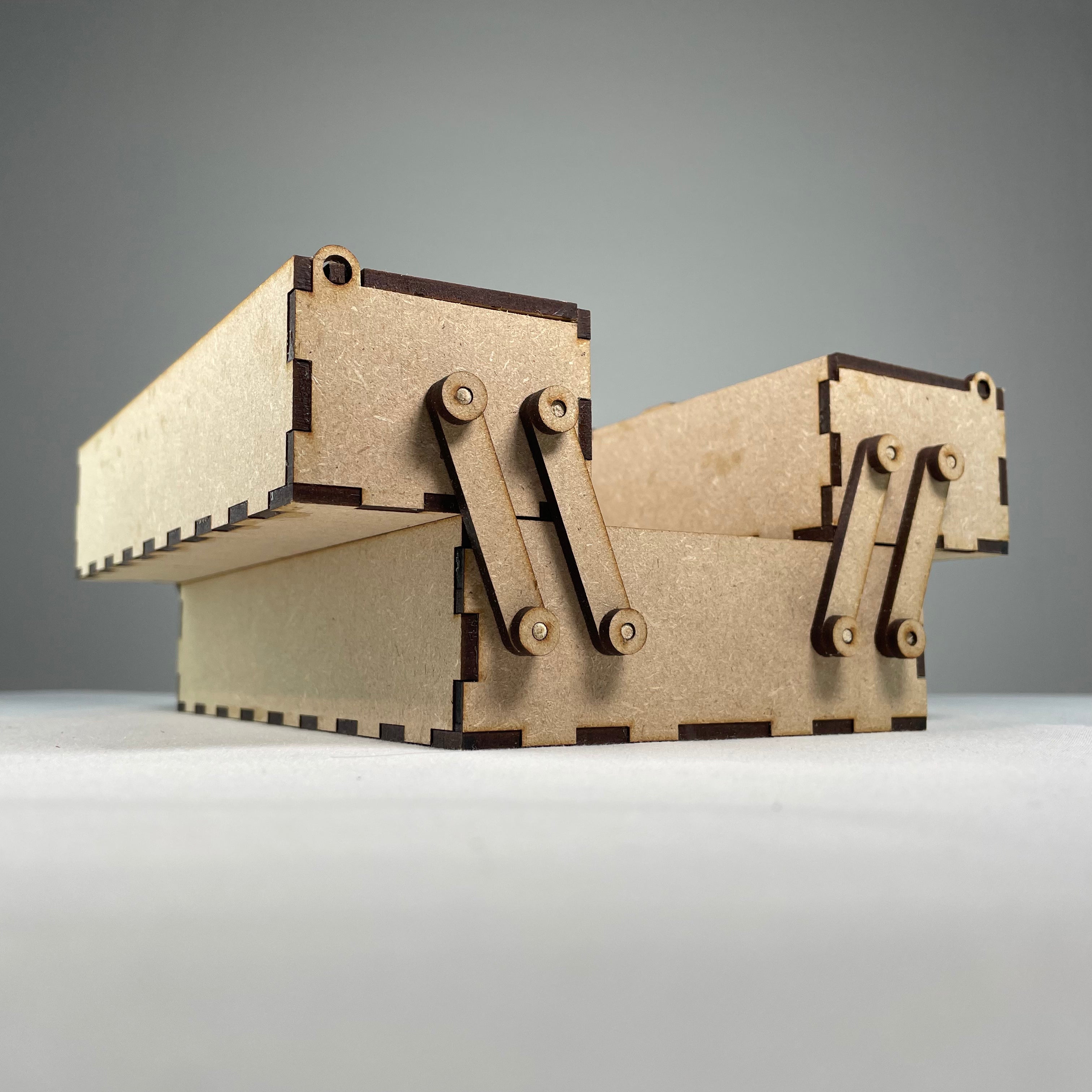 Two-tier flatpack Curious Rabbit toolbox with open compartments and handle, ready for assembly.