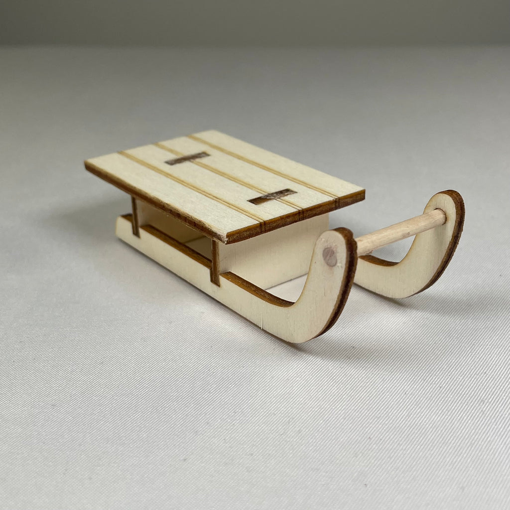 Handmade Christmas winter sledge ornament by Curious Rabbit, featuring intricate details and festive holiday design.