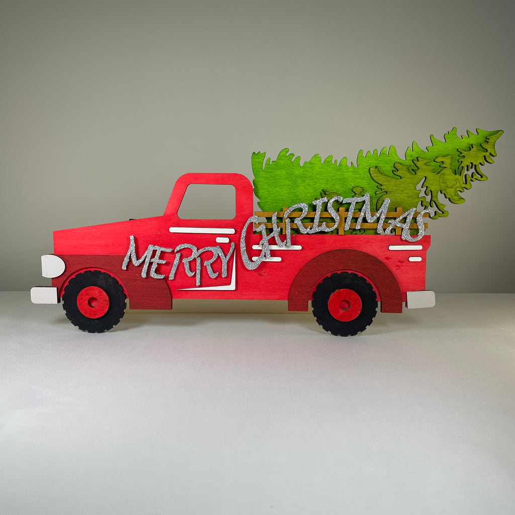 Handmade Christmas truck and tree sign ornament by Curious Rabbit, featuring festive holiday decor and cheerful holiday design.