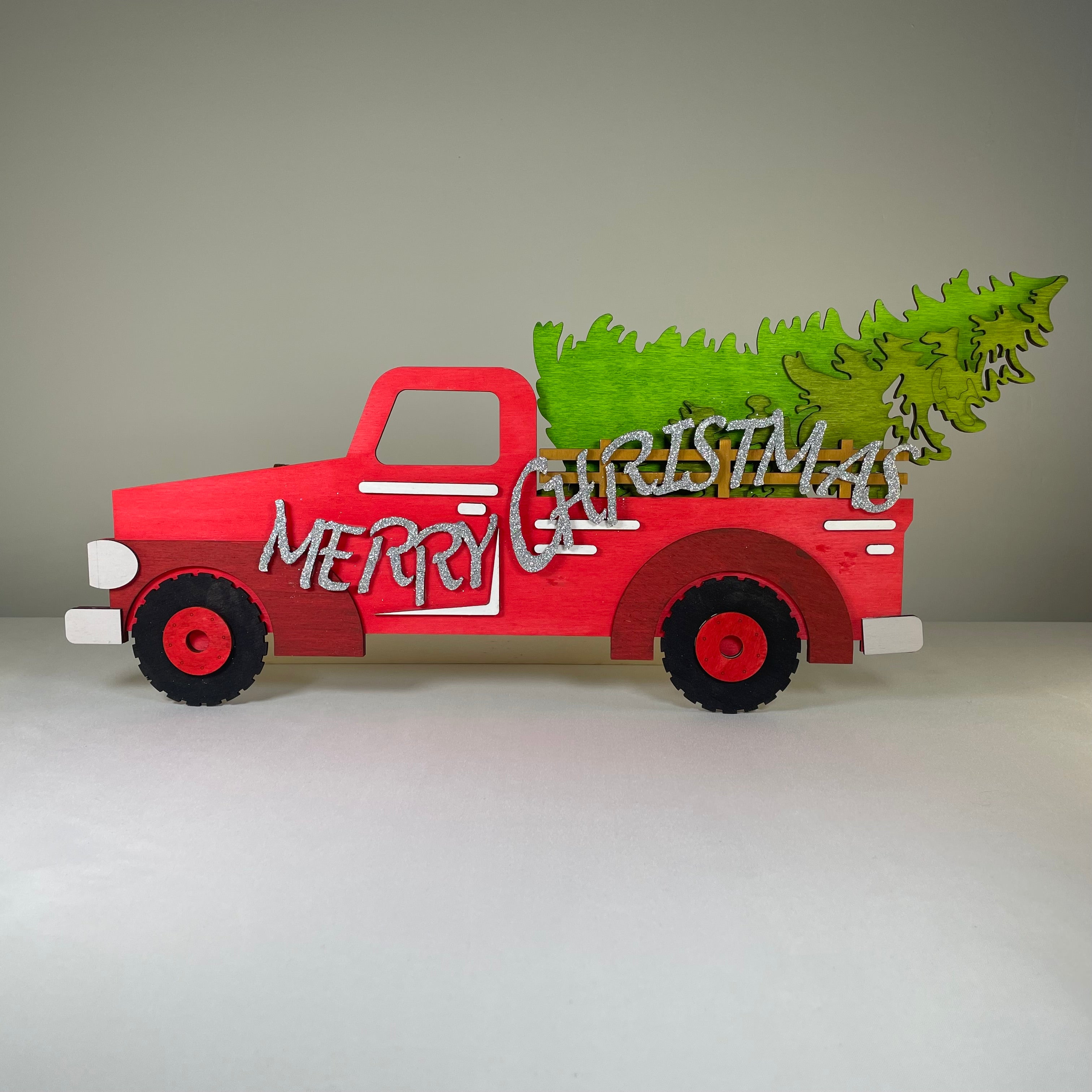Handmade Christmas truck and tree sign ornament by Curious Rabbit, featuring festive holiday decor and cheerful holiday design.