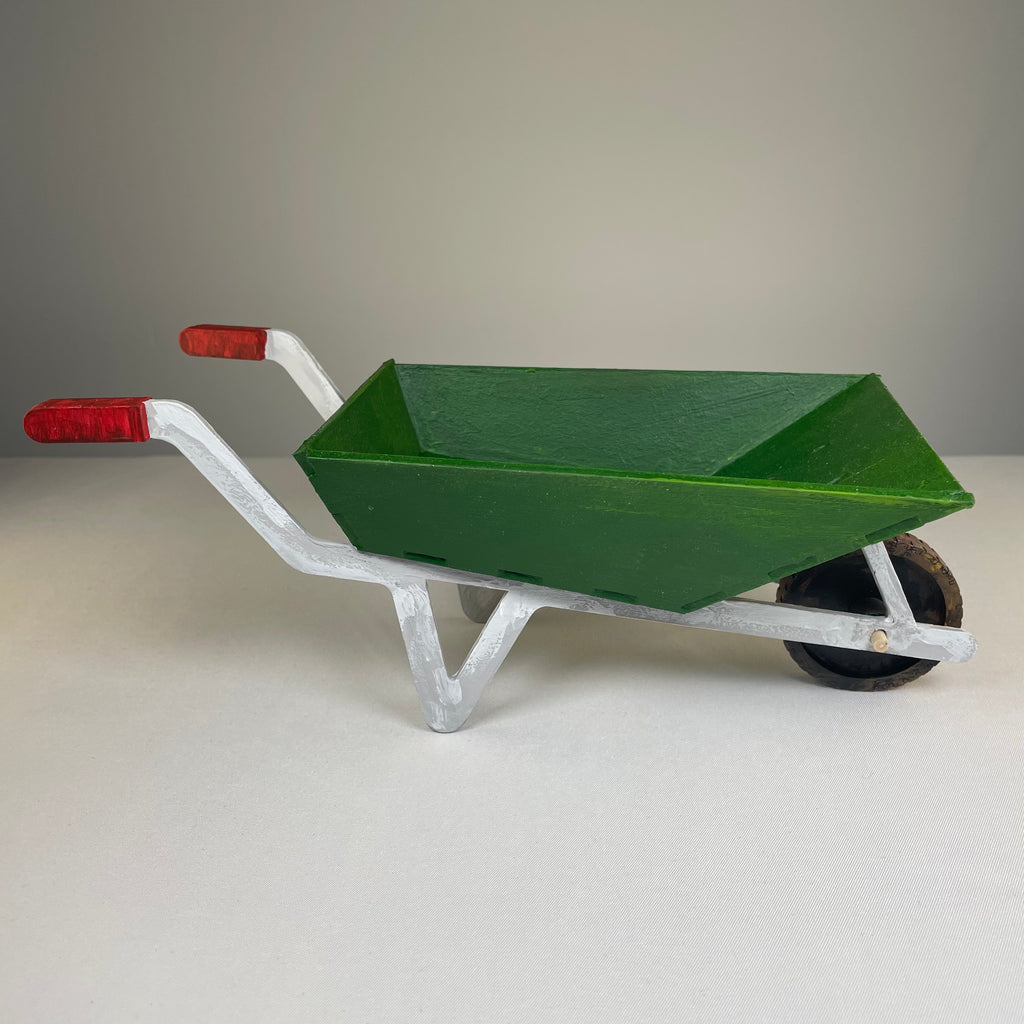 Curious Rabbit wheelbarrow planter garden kit with flatpack design, showing assembled wooden wheelbarrow with plant containers.