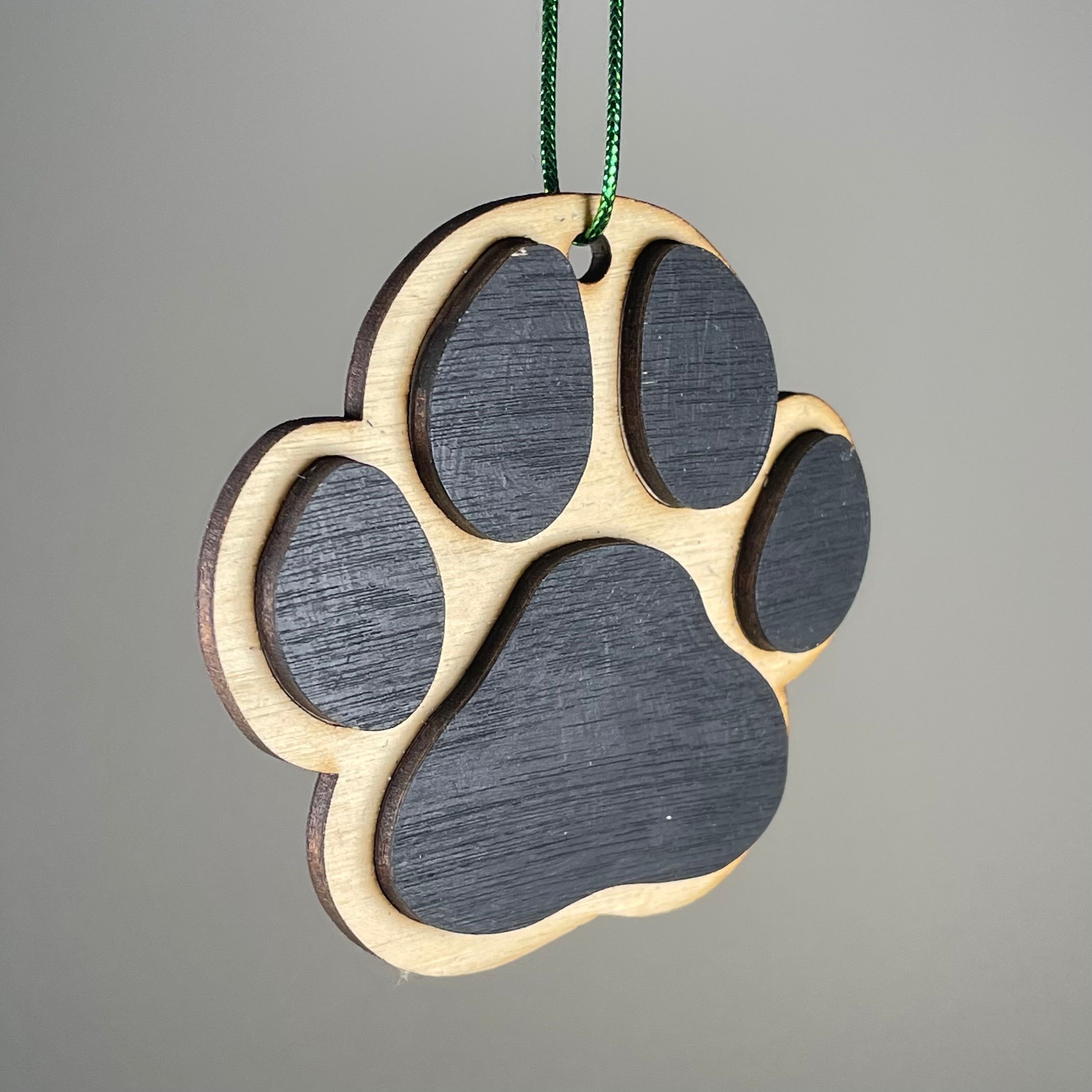 Handmade dog paw print bauble ornament by Curious Rabbit, featuring a charming pet-themed design and festive details.