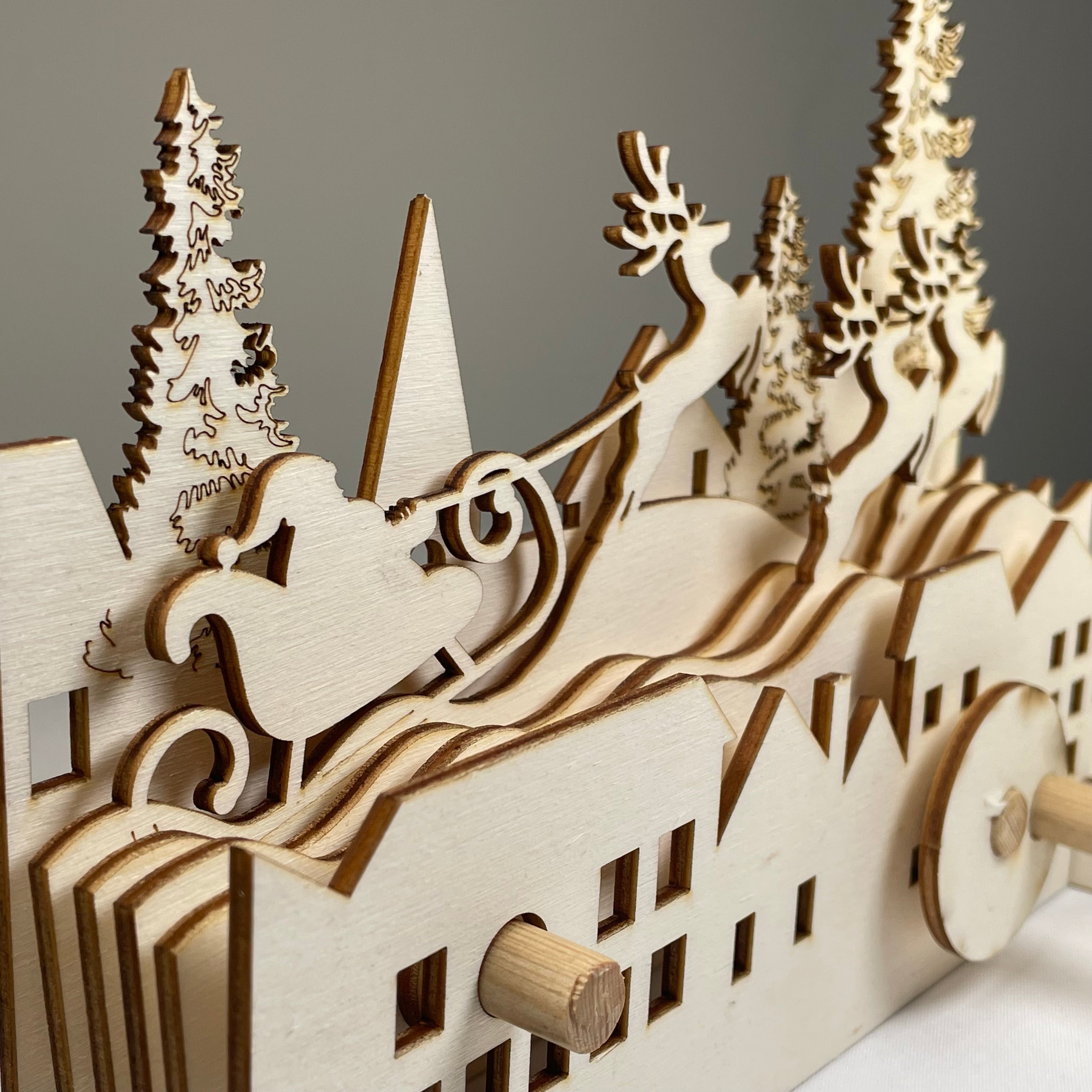 Mechanical Santa sleigh flatpack model kit by Curious Rabbit, featuring detailed Christmas-themed design and assembly parts.