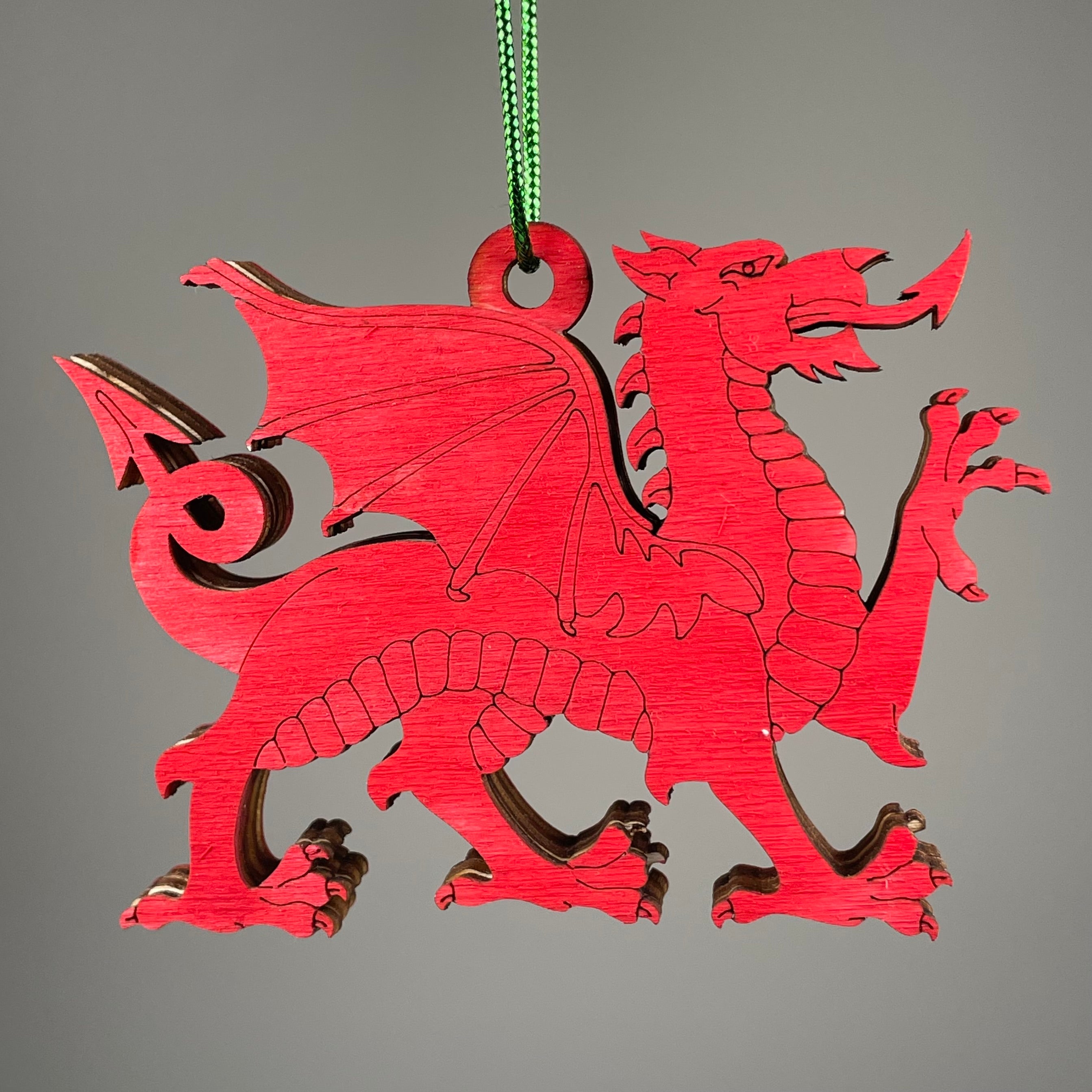 Handmade Welsh Dragon bauble ornament by Curious Rabbit, featuring a colorful dragon design on a festive holiday decoration.