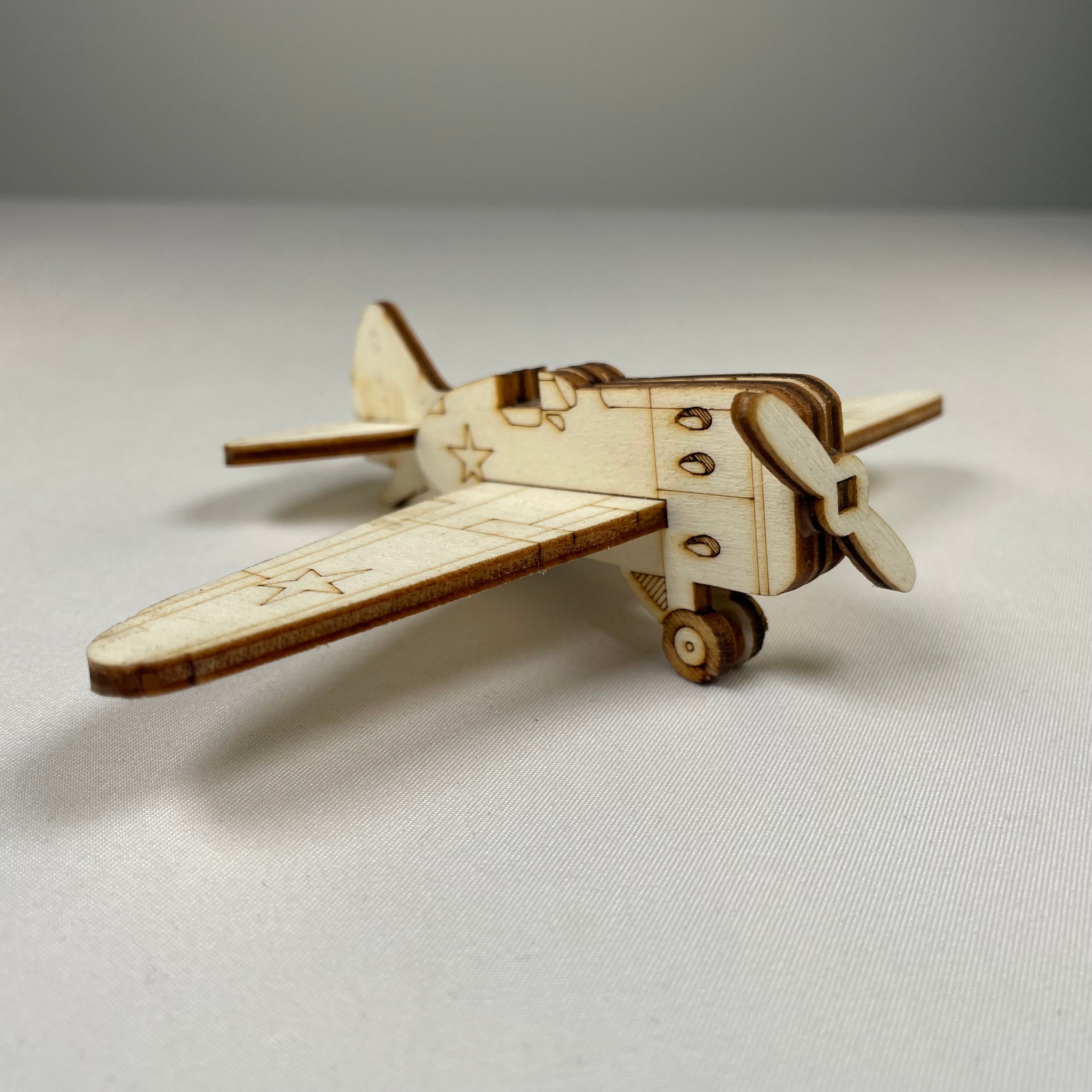 Handmade wooden airplane ornament by Curious Rabbit, vintage-style history decor suitable for wall or tabletop display.