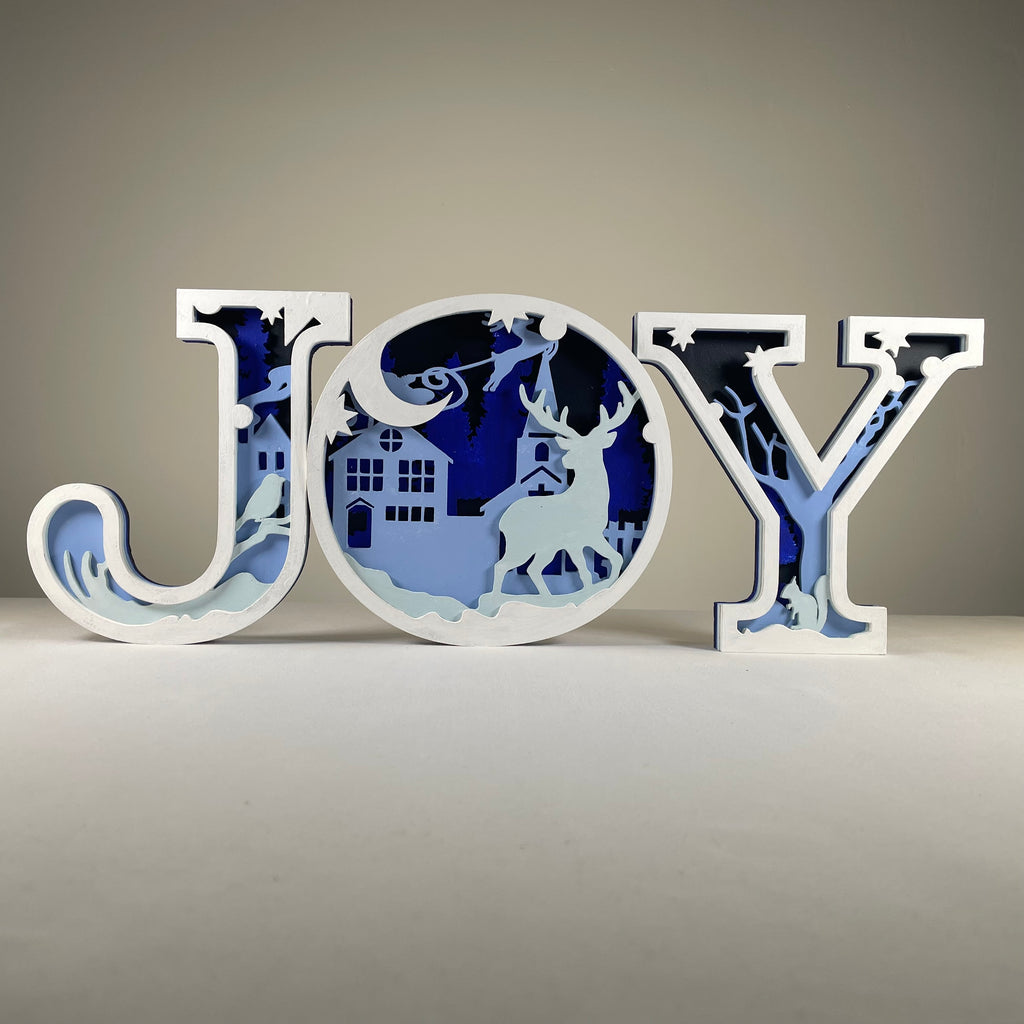 Handmade Curious Rabbit Christmas Joy sign ornament with festive holiday design and natural wood finish.