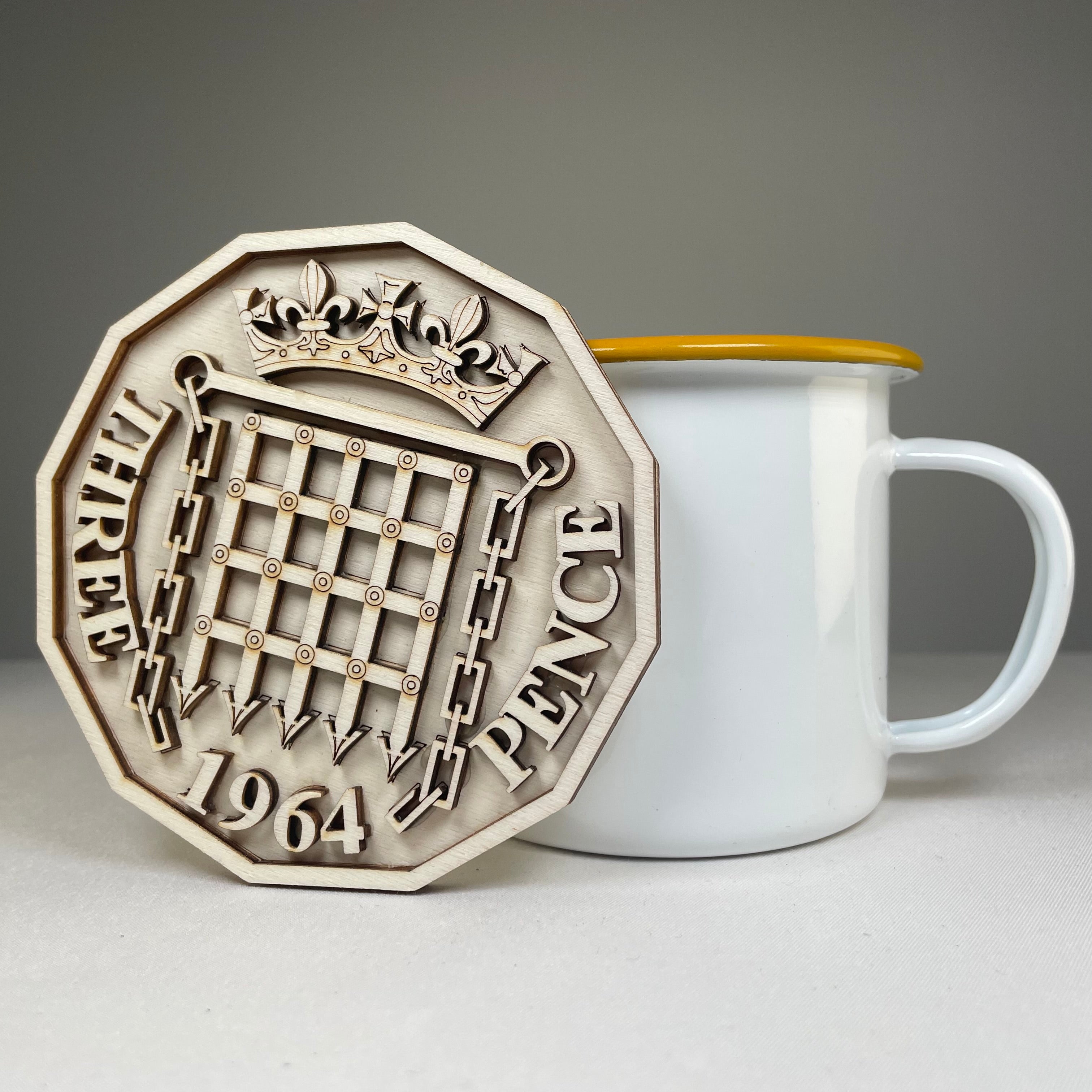 Handmade Three Pence Coaster from Curious Rabbit featuring intricate icon designs on ceramic tableware.
