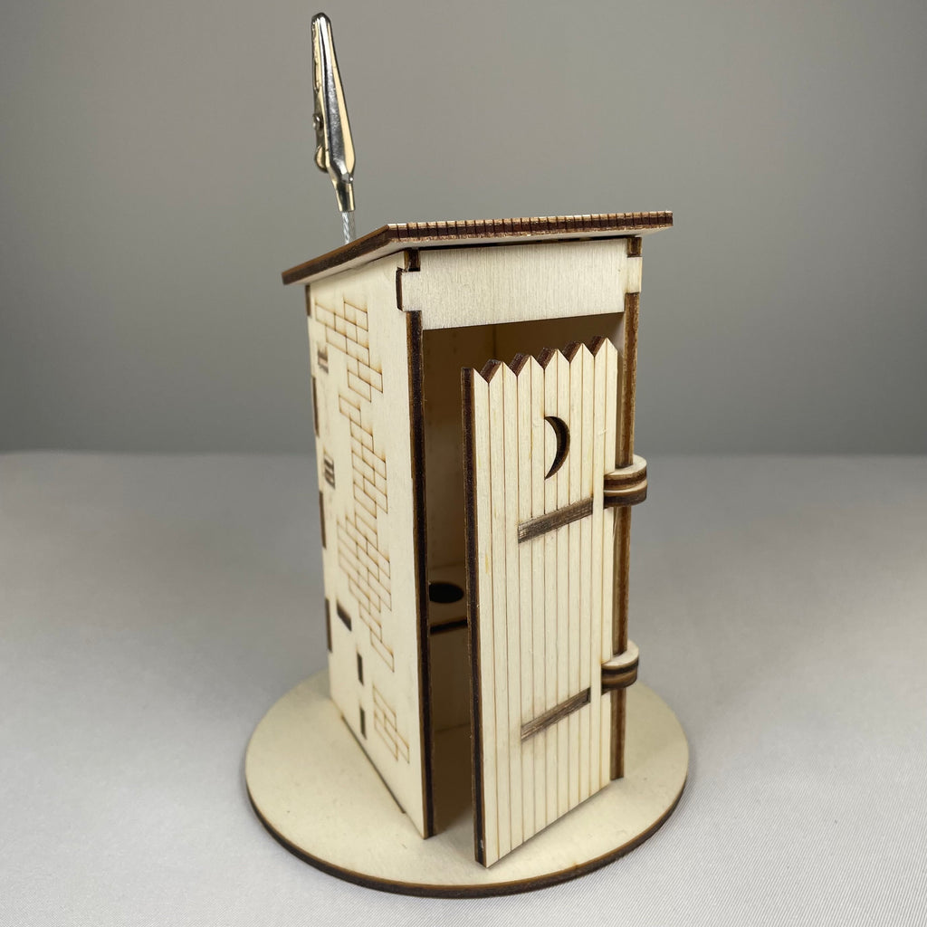 Curious Rabbit Outhouse Toilet flatpack memo holder with architecture-inspired design, made of durable material, displayed on a plain surface.