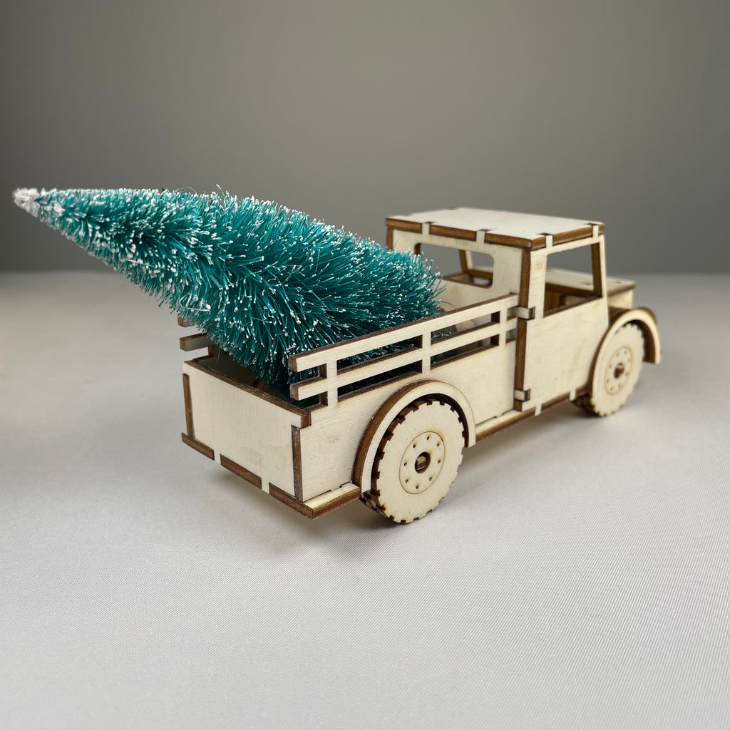 Curious Rabbit Christmas truck flatpack model kit with a Christmas tree, ready to be assembled for holiday decoration.