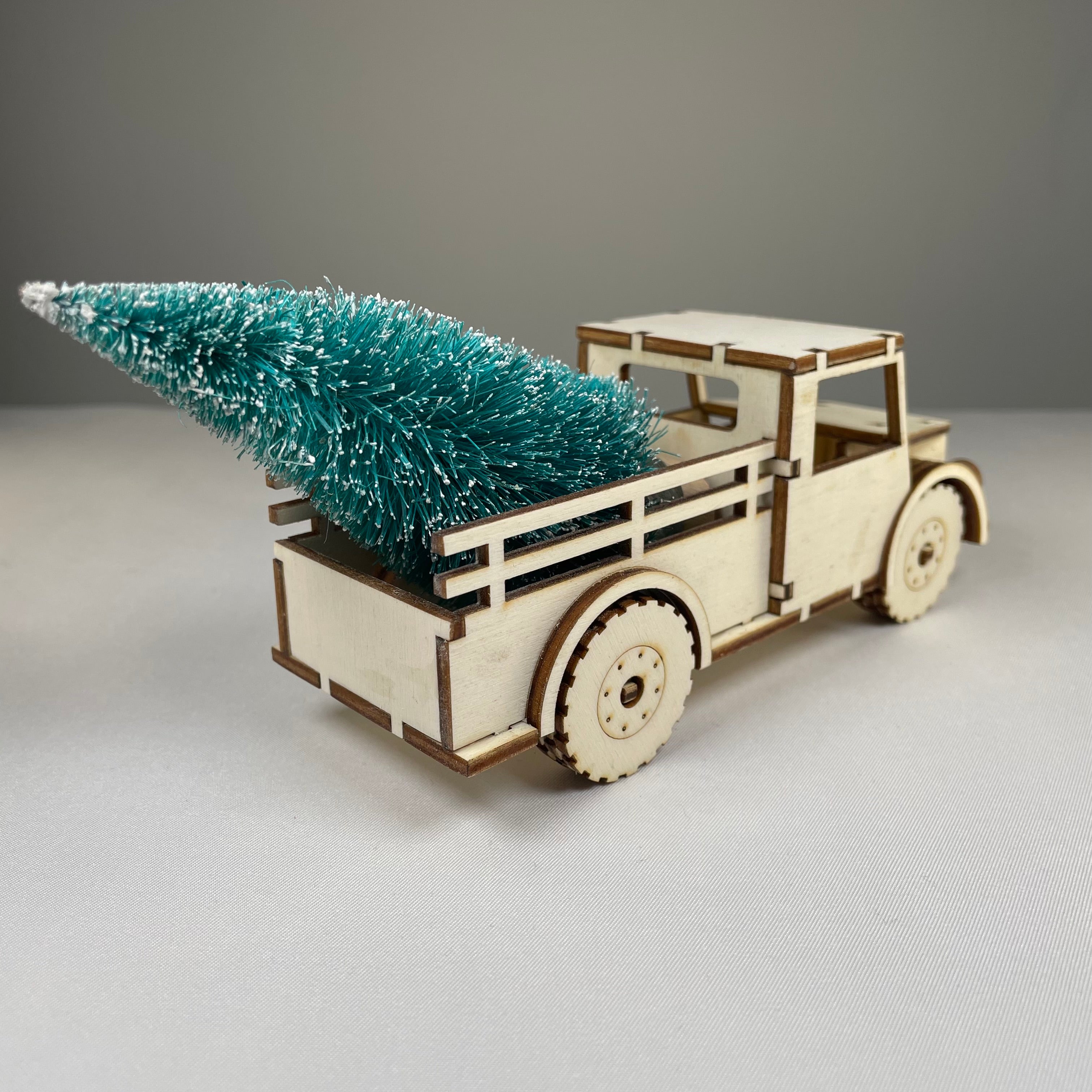 Curious Rabbit Christmas truck flatpack model kit with a Christmas tree, ready to be assembled for holiday decoration.