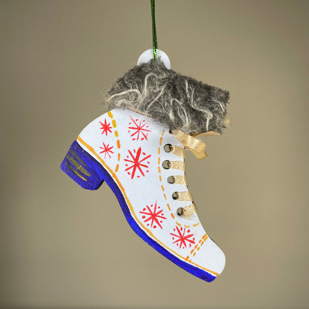 Handmade Christmas ice skate ornament in white with silver accents, designed by Curious Rabbit, perfect for holiday decoration.
