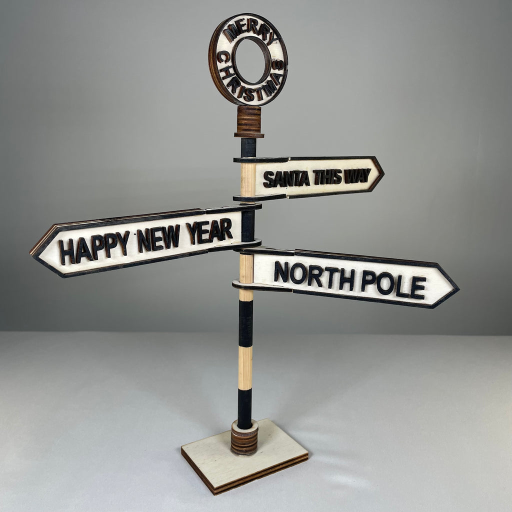 Handmade Christmas Direction Sign ornament by Curious Rabbit, featuring colorful directional arrows for holiday decor.