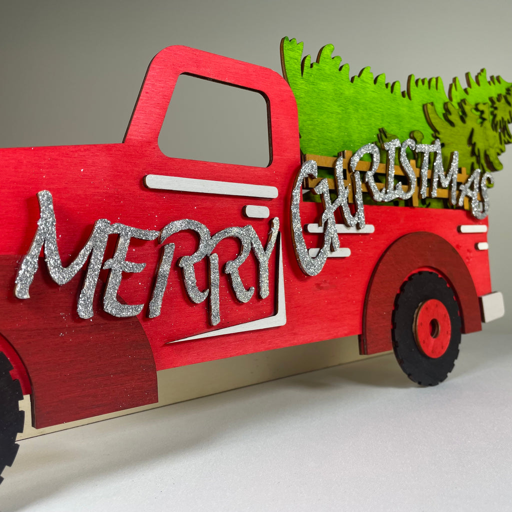 Handmade Christmas truck and tree sign ornament by Curious Rabbit, featuring festive holiday decor with cheerful holiday design.