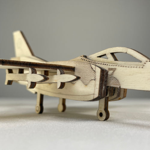 Curious Rabbit Jet Puzzle flatpack model kit featuring a detailed historical jet aircraft assembled from colorful pieces.