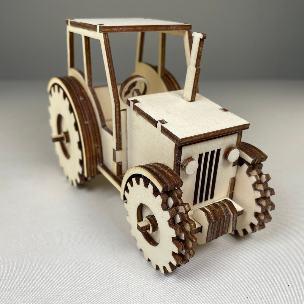 Curious Rabbit garden tractor puzzle flatpack model kit, assembled view showing colorful plastic pieces and detailed tractor design.