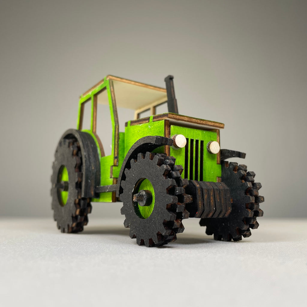 Curious Rabbit garden tractor puzzle flatpack model kit with colorful pieces and assembly instructions.