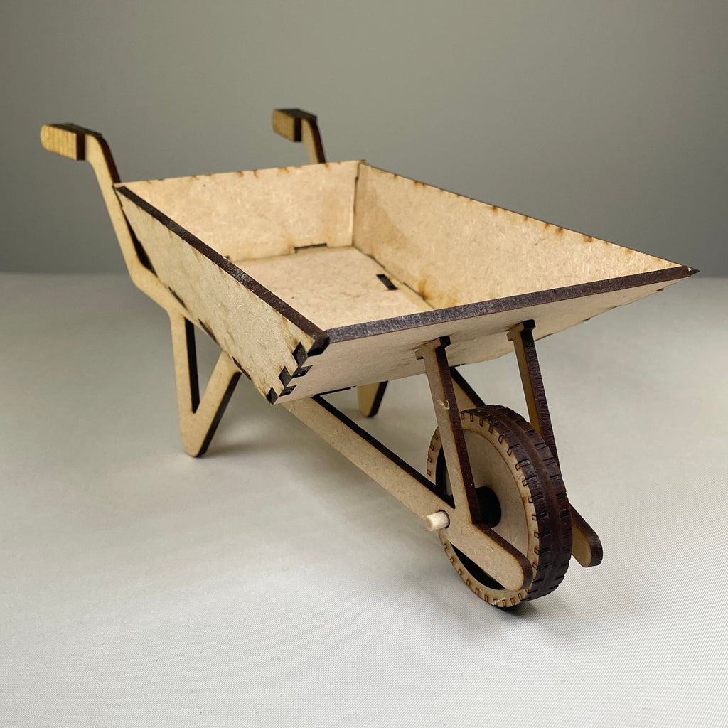 Curious Rabbit wheelbarrow planter garden kit with flatpack design, featuring a miniature wheelbarrow shape for outdoor plant display.