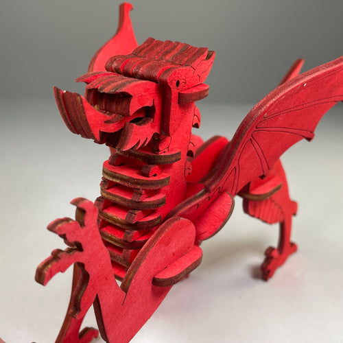 Curious Rabbit Welsh Dragon puzzle flatpack model kit showing assembled colorful Welsh dragon design on a flat surface.