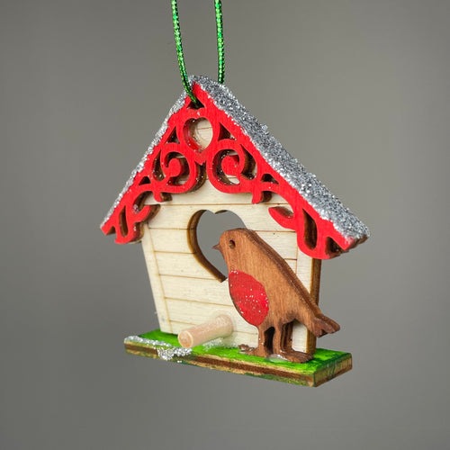 Handmade Curious Rabbit Christmas birdhouse bauble ornament hanging on a tree branch, festive holiday decoration with detailed craftsmanship.