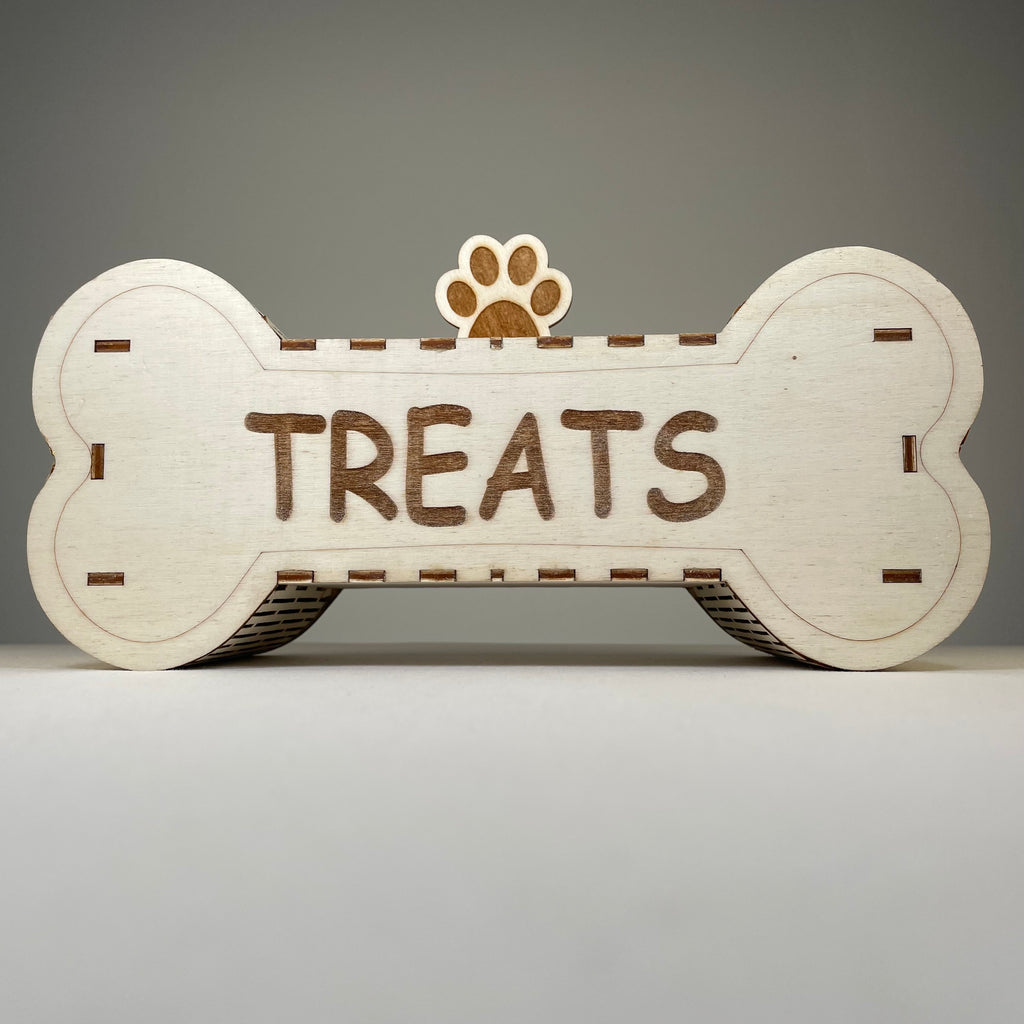 Curious Rabbit dog treat box flatpack model kit for pets, featuring assembled cardboard box with colorful pet treats and packaging materials.