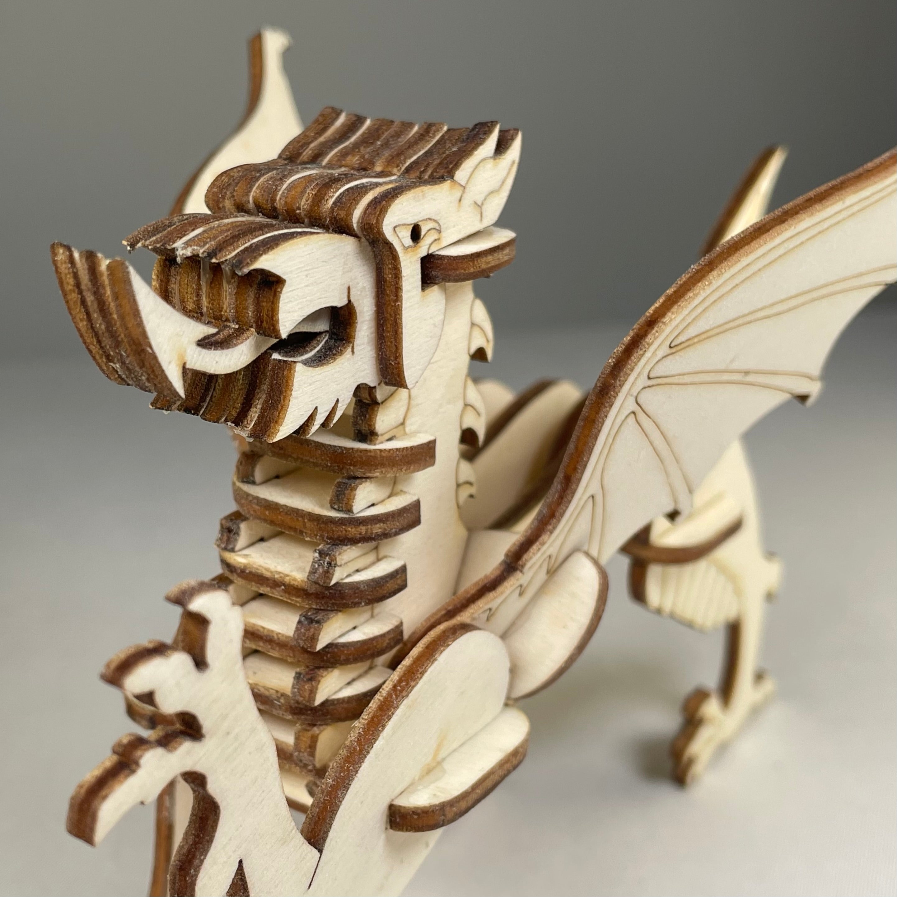 Curious Rabbit Welsh Dragon puzzle model kit featuring a flatpack design, showcasing intricate dragon details in vibrant colors.