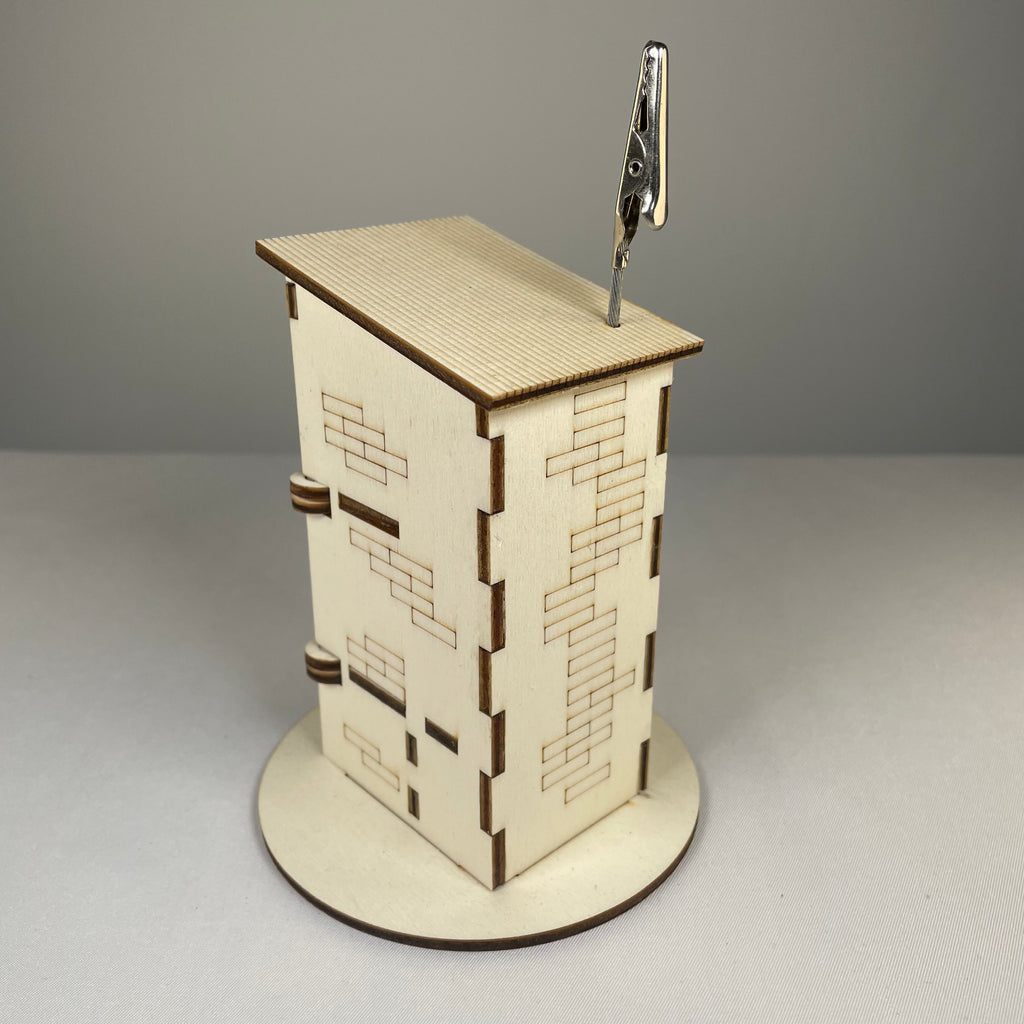 Curious Rabbit Outhouse Toilet flatpack memo holder with architectural design, showcasing detailed model and packaging.