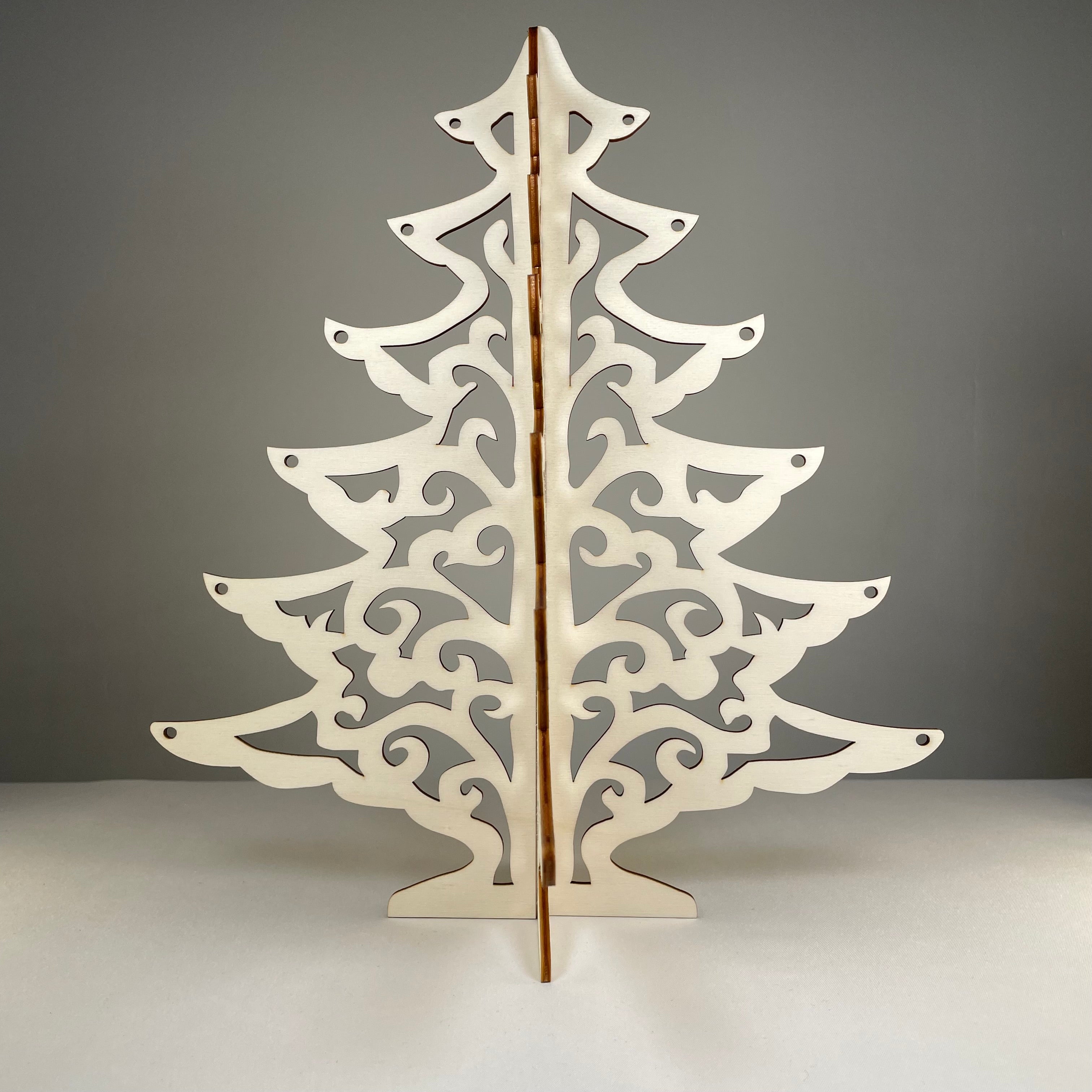 Curious Rabbit Christmas Tree flatpack model kit with assembled tree showing layered green branches and wooden base.