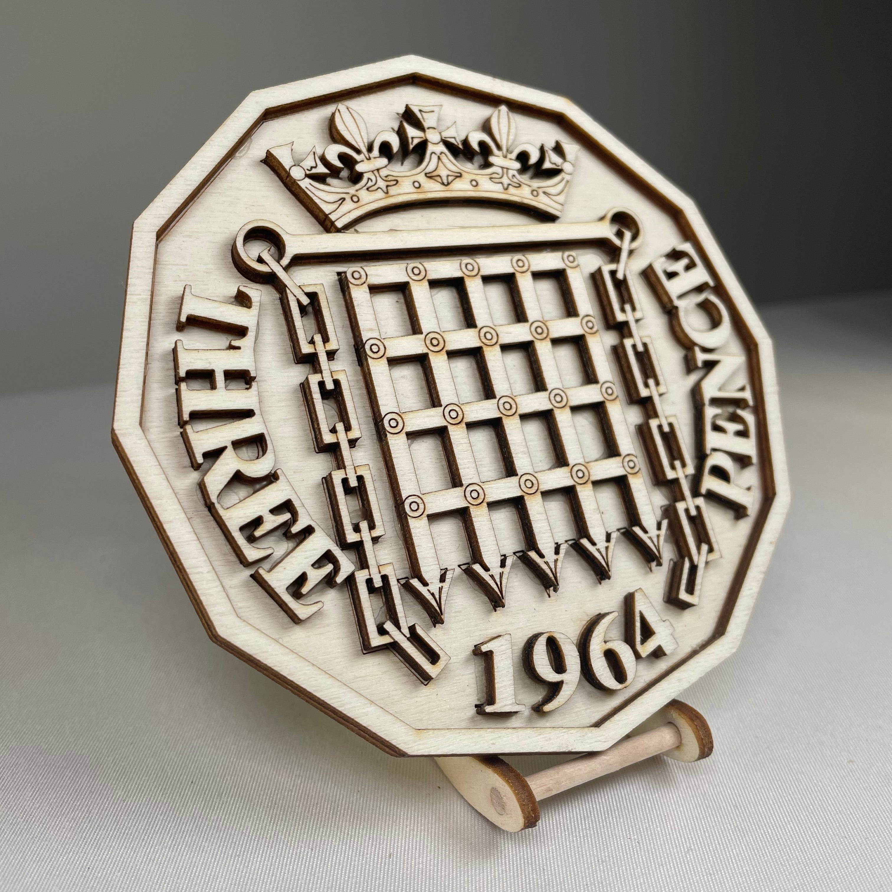 Handmade Three Pence Coaster with Curious Rabbit icons, featuring detailed, artistic tableware design on a wooden surface.