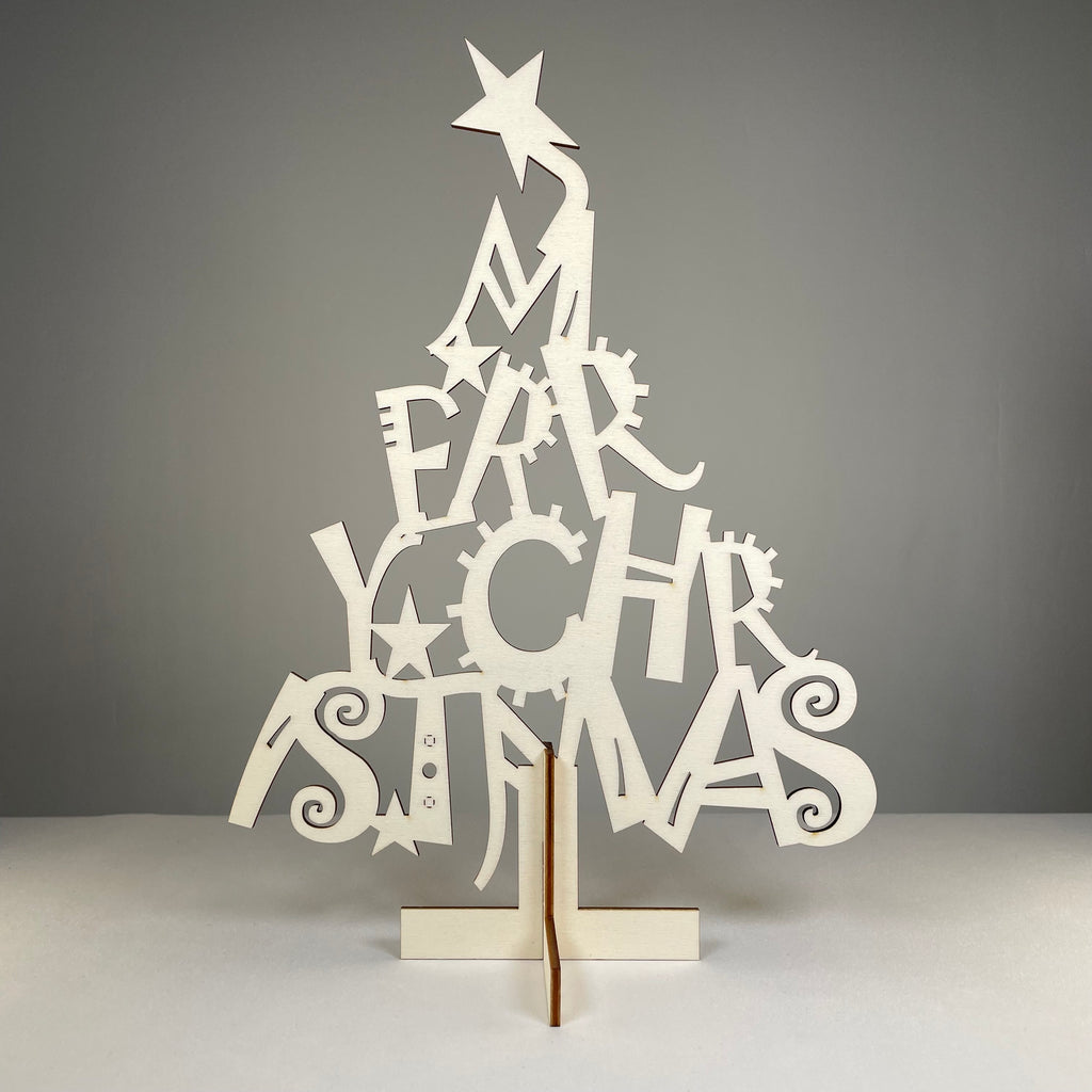 Curious Rabbit flatpack Christmas tree model kit with assembled miniature tree and packaging, perfect for holiday decorations.