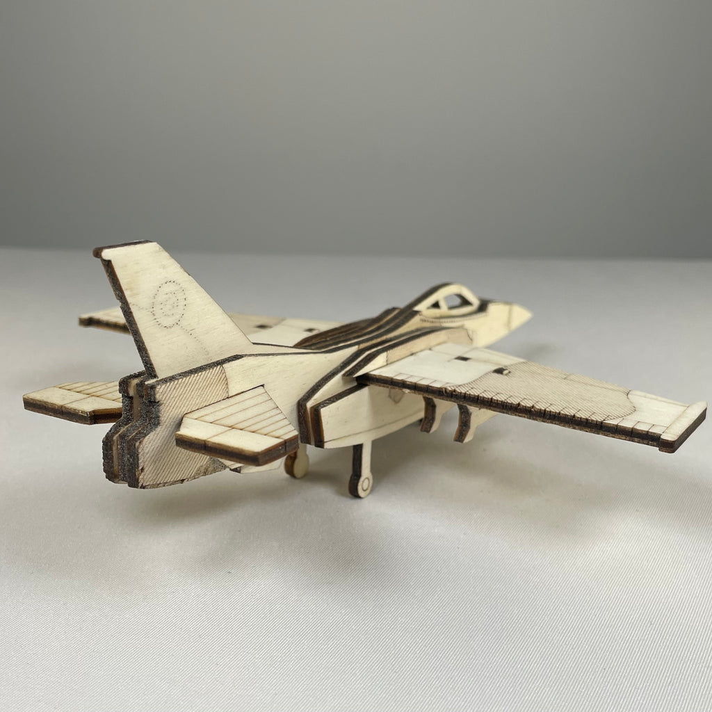 Curious Rabbit Jet Puzzle flatpack model kit featuring detailed historical aircraft components, assembled and displayed.