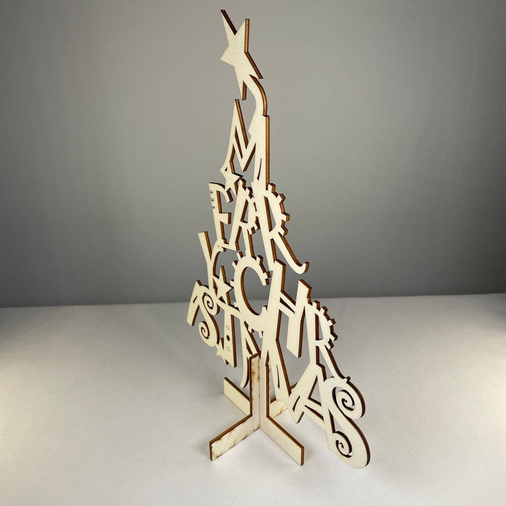 Curious Rabbit Christmas Tree flatpack model kit assembled with green branches and wooden base, ready for holiday decorations.